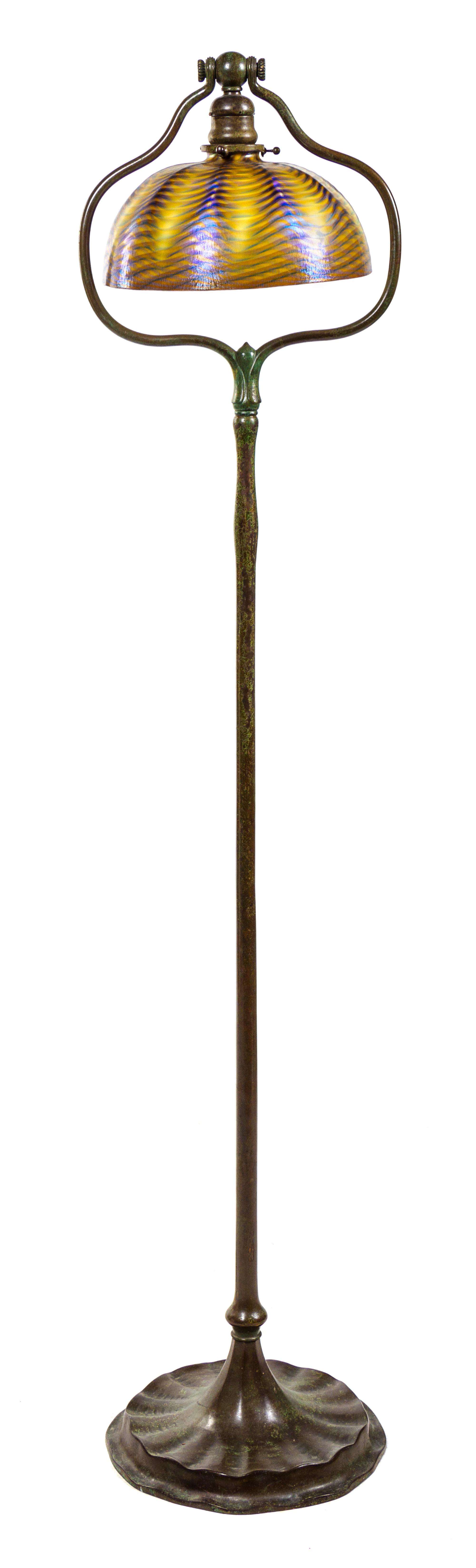 A Tiffany Favrile Glass and Bronze Floor Lamp Height 55 1/2 x diameter of shade 10 inches.
