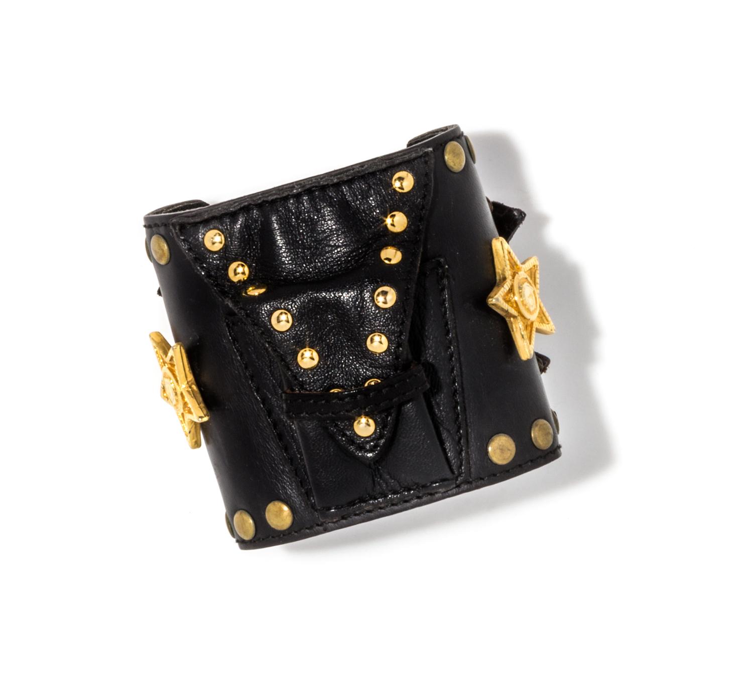 A Gianni Versace Black Leather Star Cuff with Matching Single Earclip, Width: 3"; Diameter: 7.75"- 8.75"; Earclip: 1" x 1".