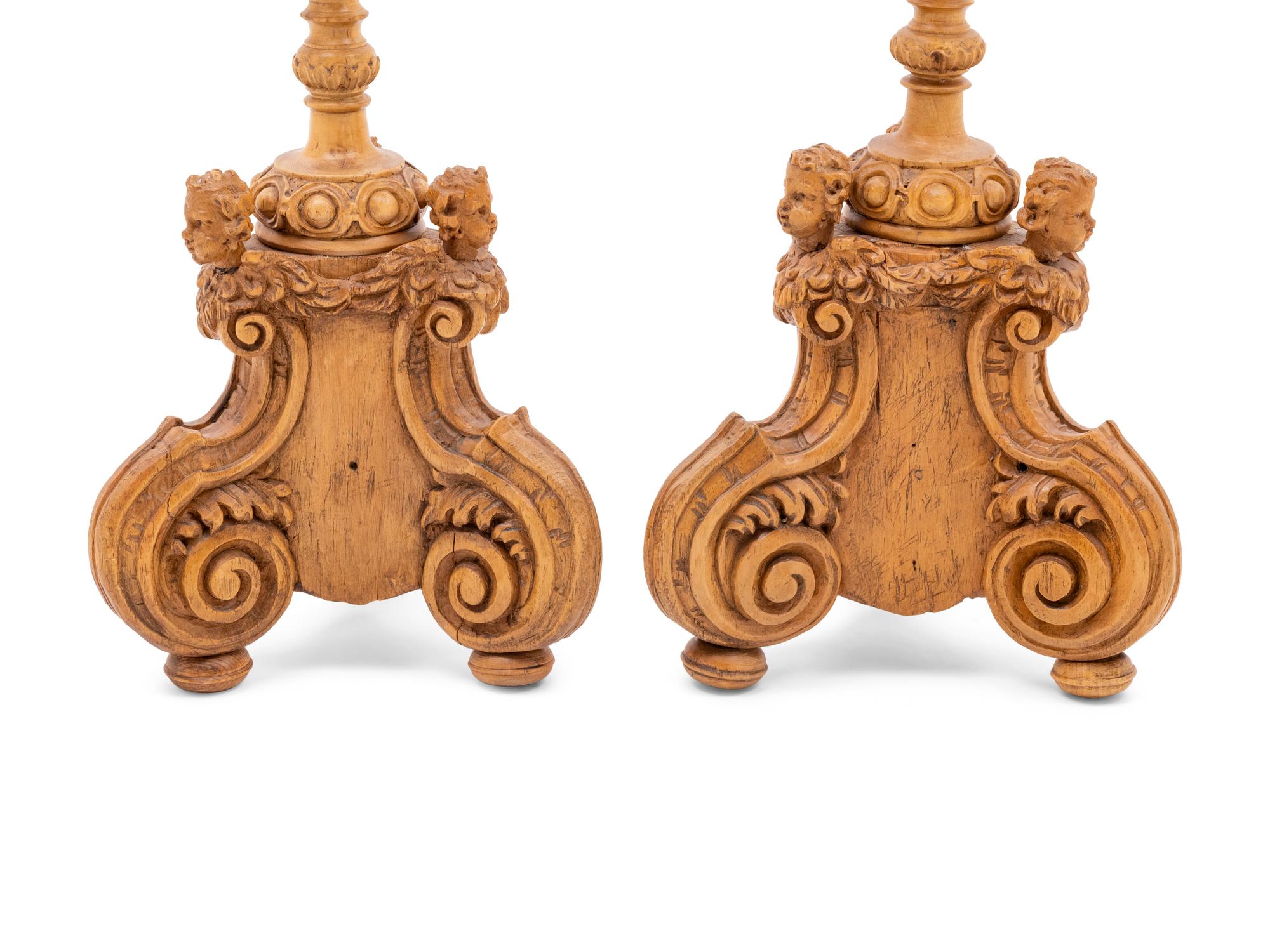 A Pair of Continental Carved Wood Prickets