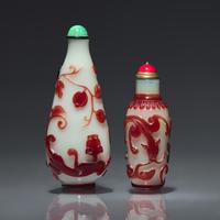 Two Chinese Ruby-Overlay Glass Bottles, Qing dynasty, Circa 1770-1880 — 1770-1880年 白地套寶石紅料螭龍紋鼻煙壺兩支