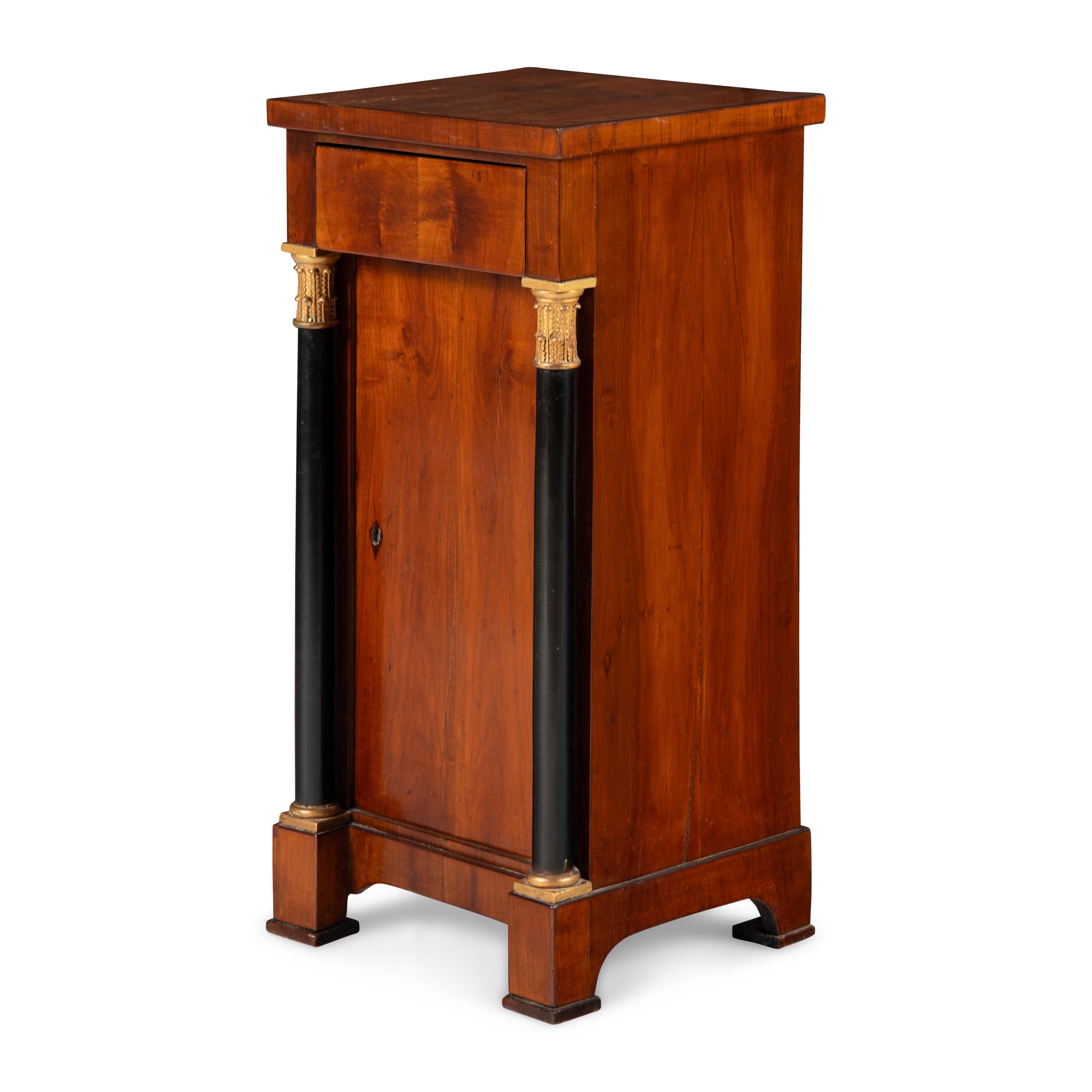 An Austrian Neoclassical Fruitwood, Ebonized and Parcel Gilt Side Cabinet