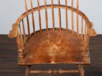 A Volute and Scroll Carved and Reel Turned Windsor Armchair
