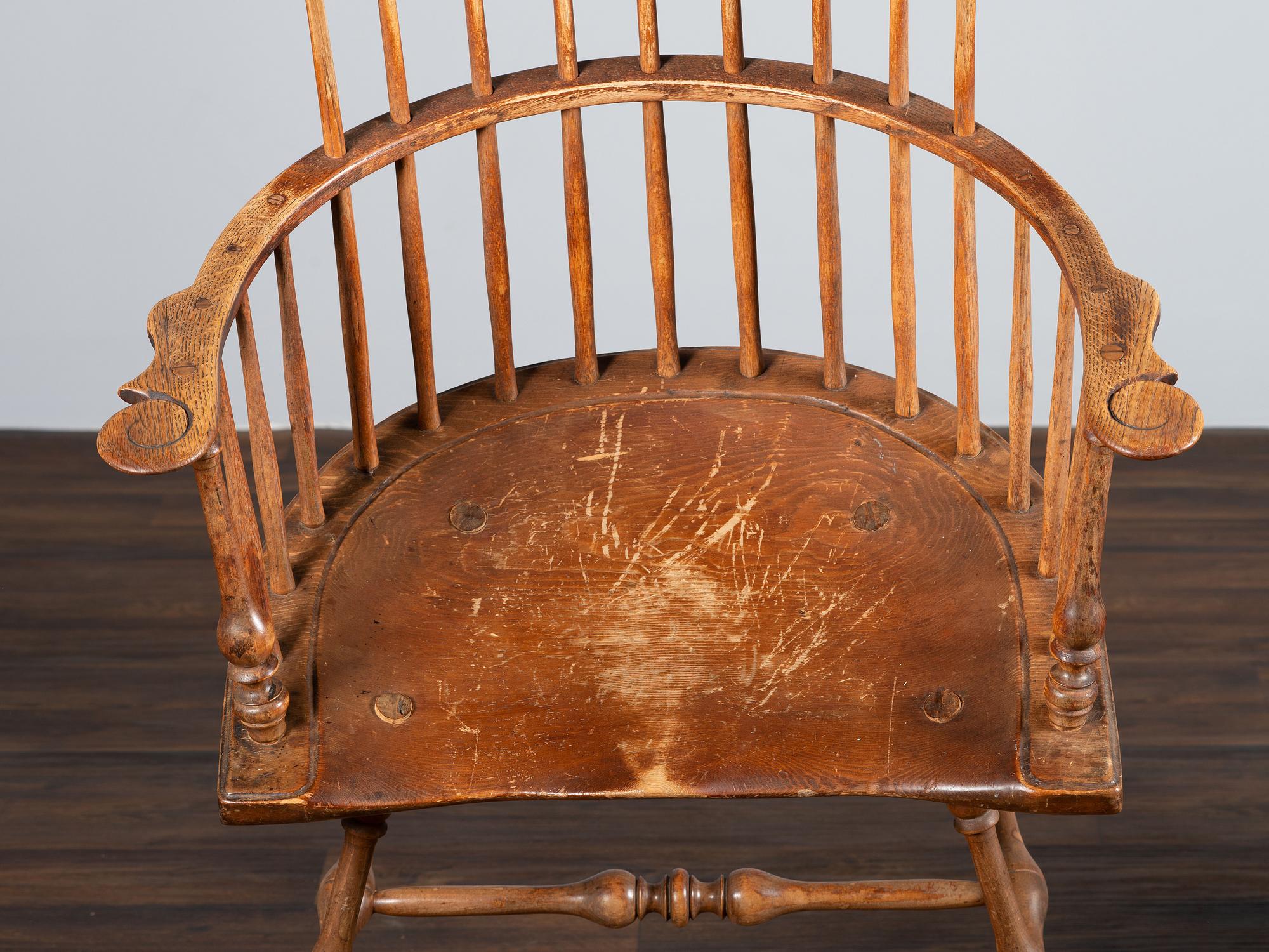 A Volute and Scroll Carved and Reel Turned Windsor Armchair