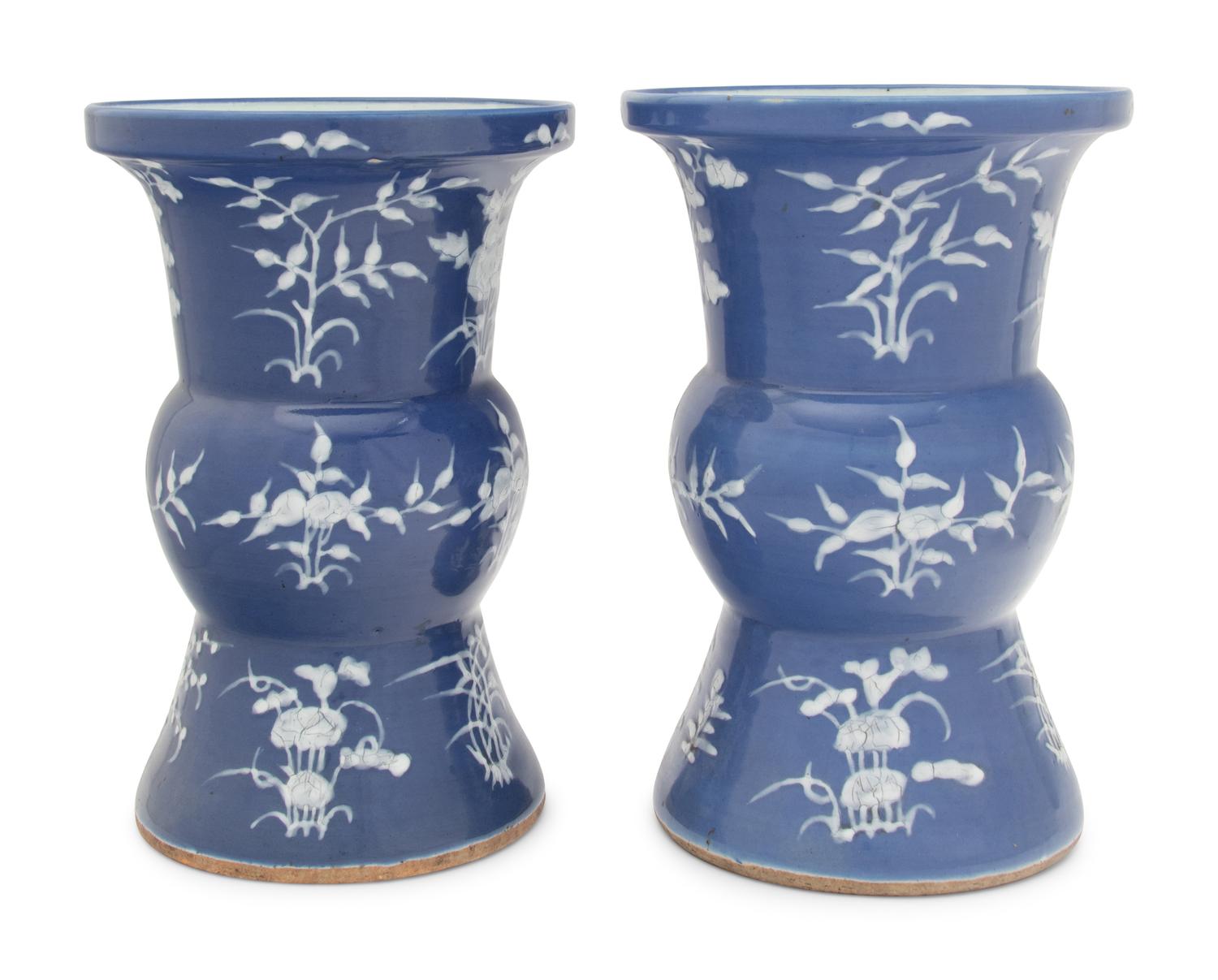 A Pair of Chinese Blue Ground White Slip Decorated Porcelain Spittoons
