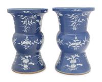 A Pair of Chinese Blue Ground White Slip Decorated Porcelain Spittoons