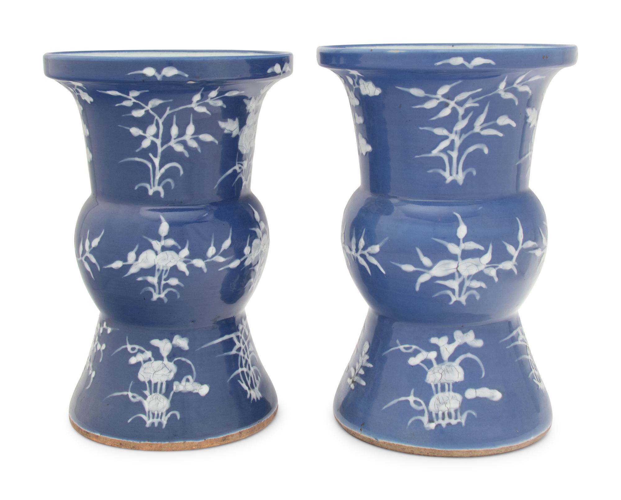 A Pair of Chinese Blue Ground White Slip Decorated Porcelain Spittoons