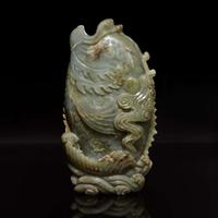 A Chinese carved celadon jade figure of a leaping carp 青玉鯉躍龍門花插