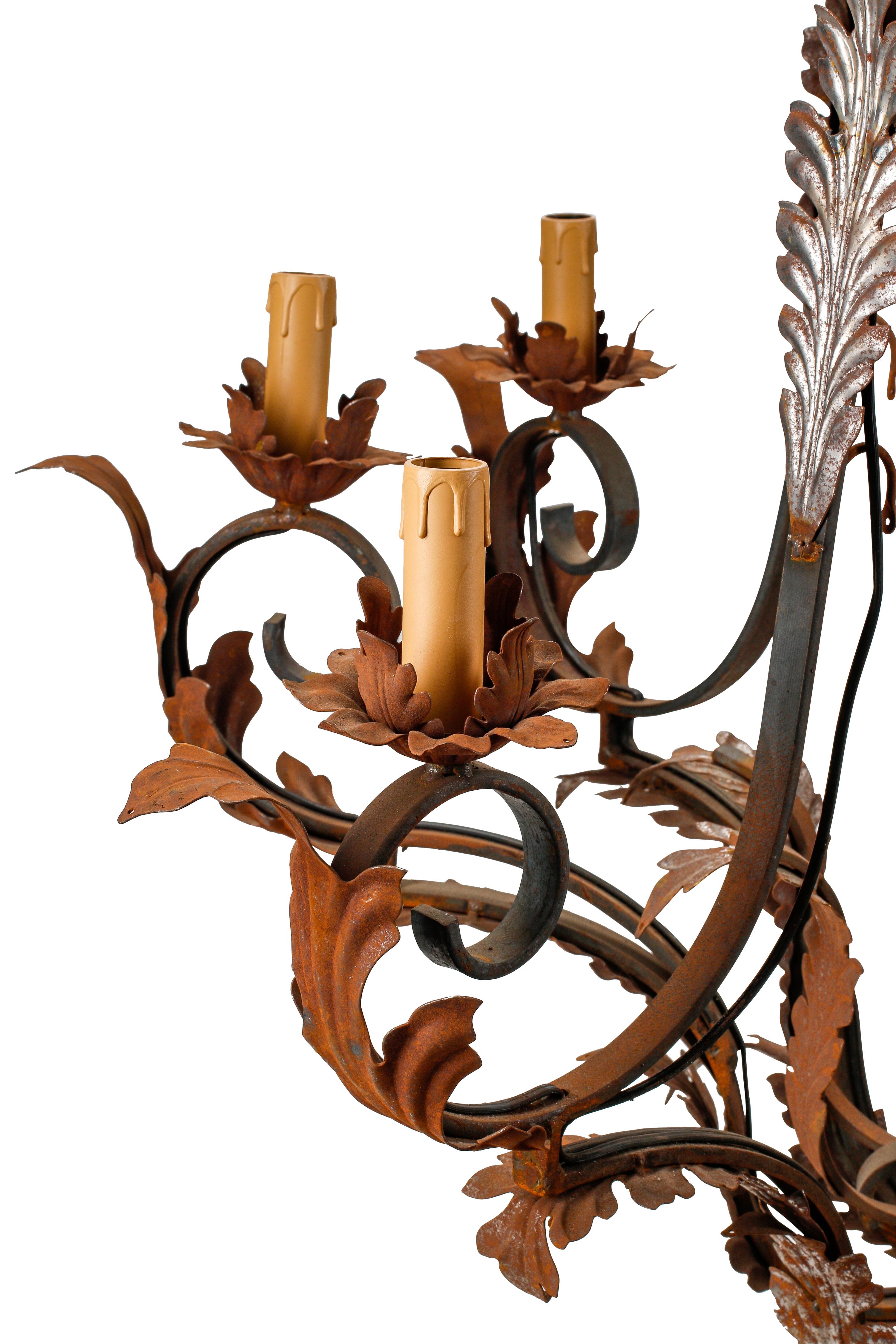 A Pair of Spanish Iron and Tole Eight-Light Chandeliers