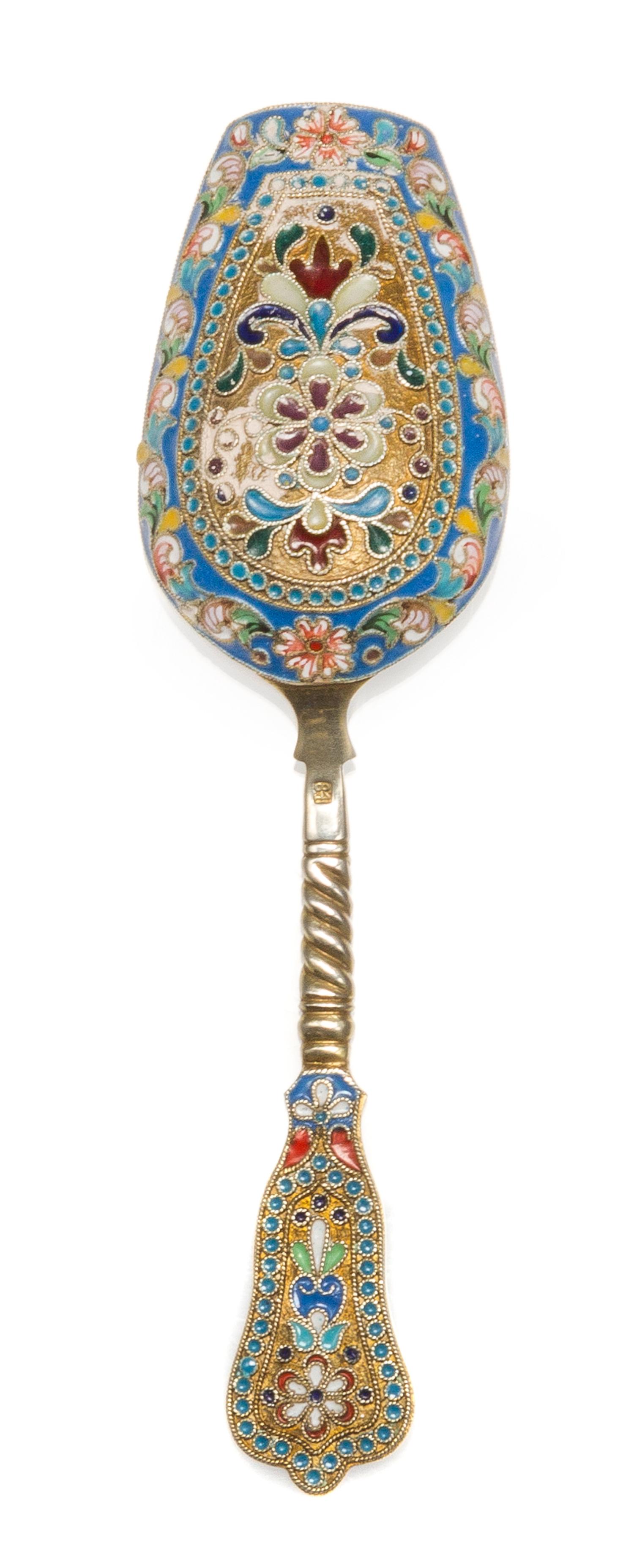 A Russian Enameled Silver and Plique-a-Jour Tea Scoop, , having a polychrome enamel and twist decorated handle, the scoop surrounded wi
