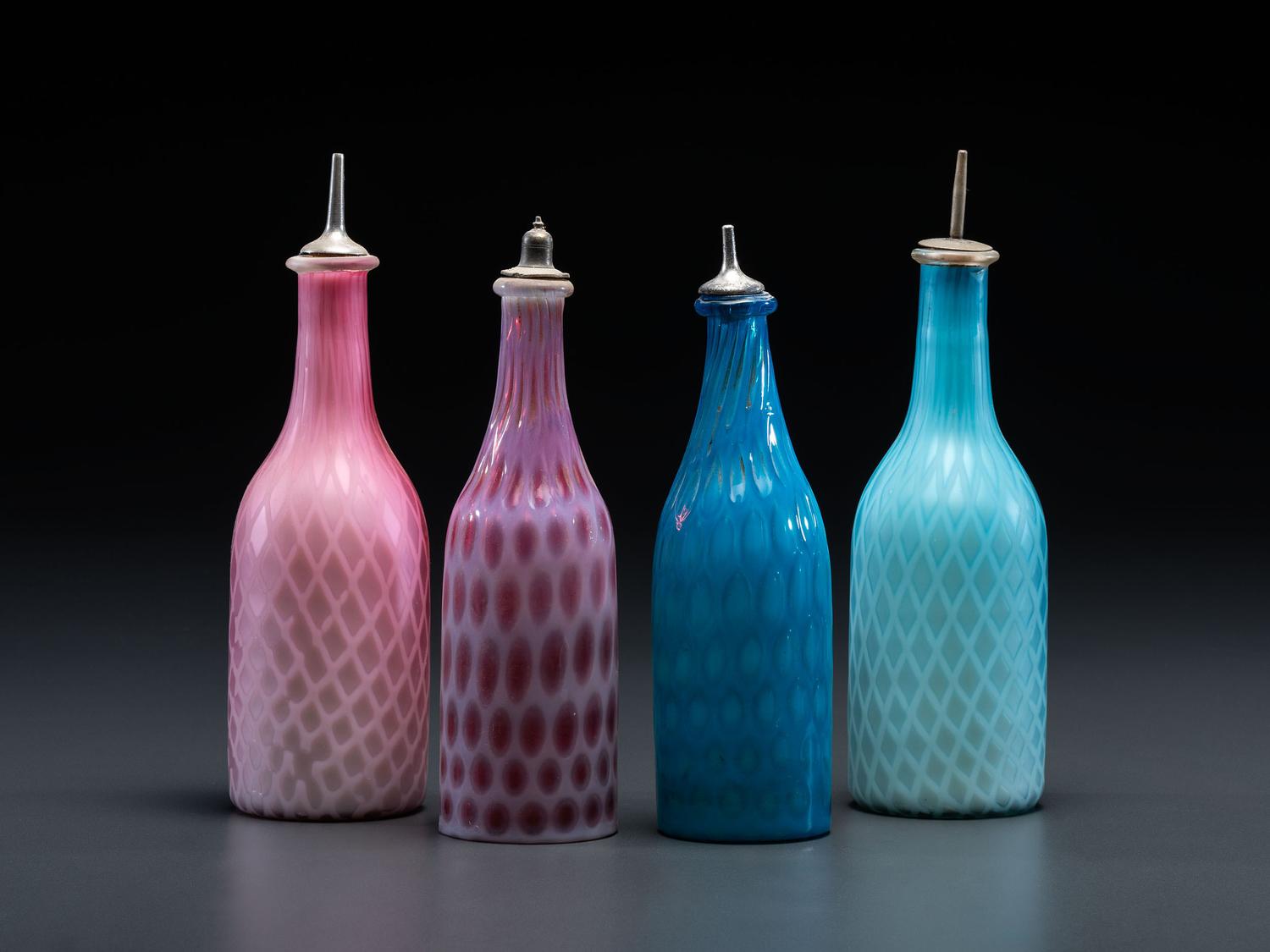 Four Opalescent Glass Barber Bottles