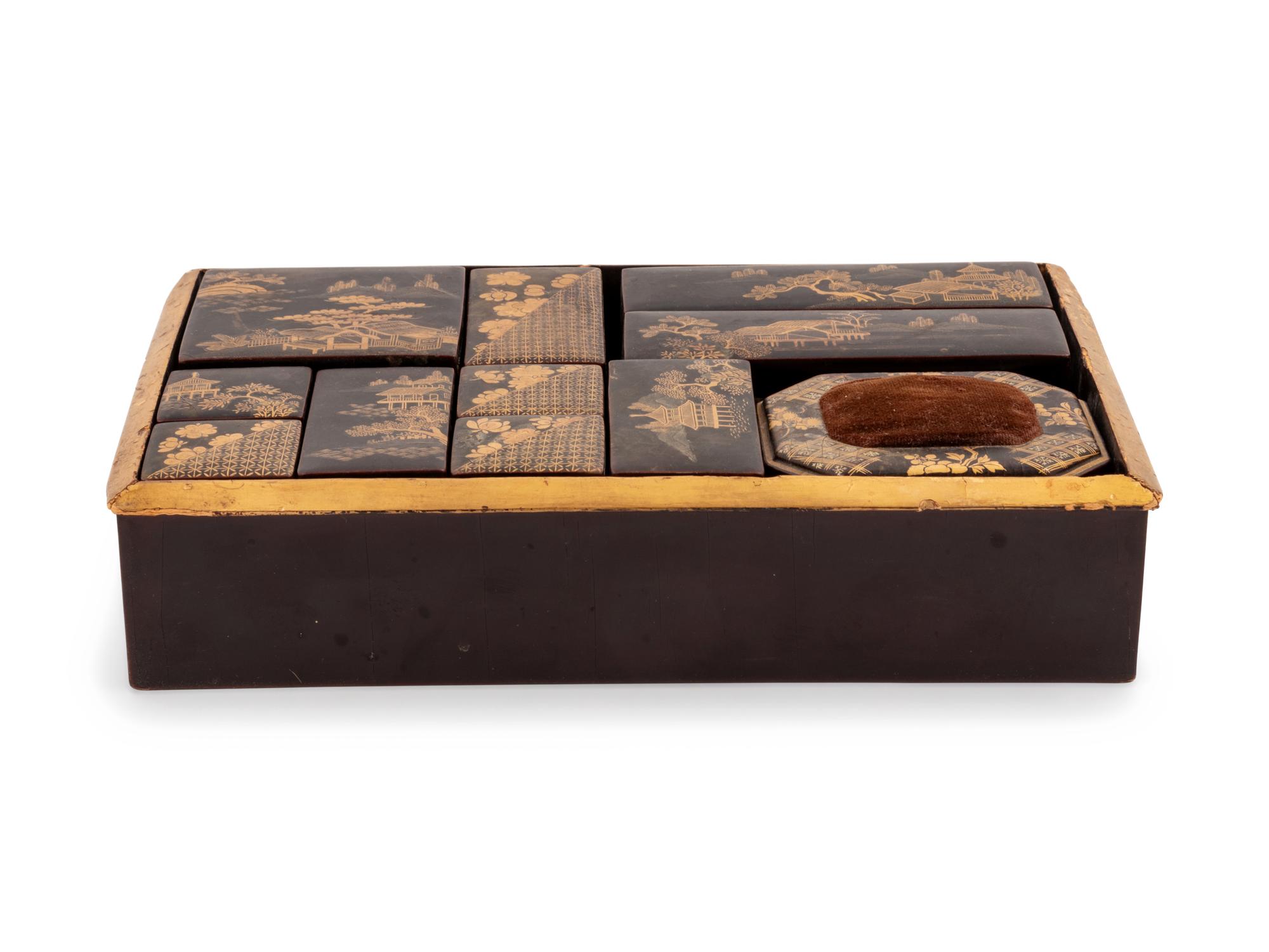 A Set of Eleven Small Japanese Gilt and Black Lacquer Stationary Boxes