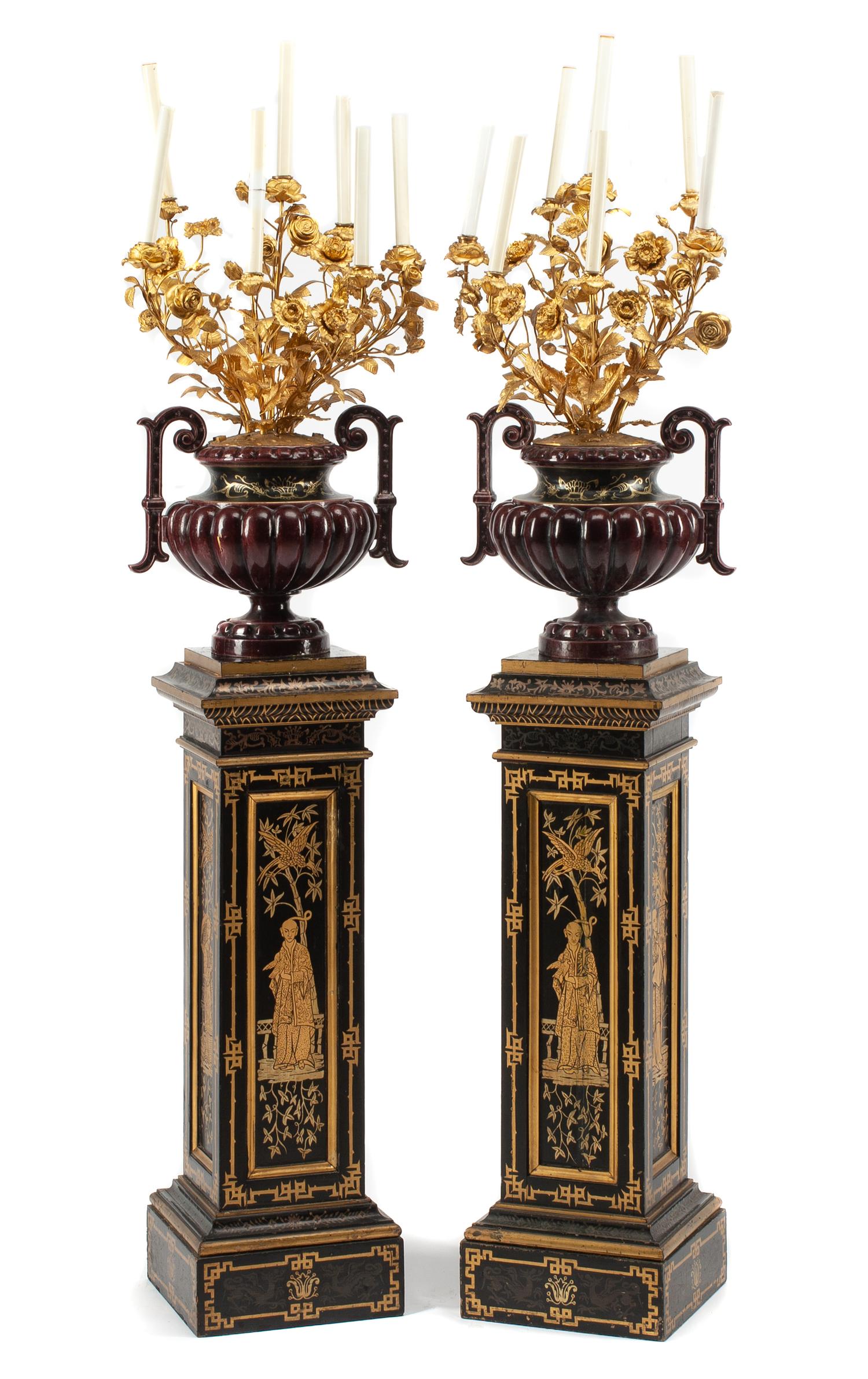 A Pair of French Enameled Cast Iron and Gilt Bronze Candelabra with Associated Painted Pedestals Height overall 69 inches.