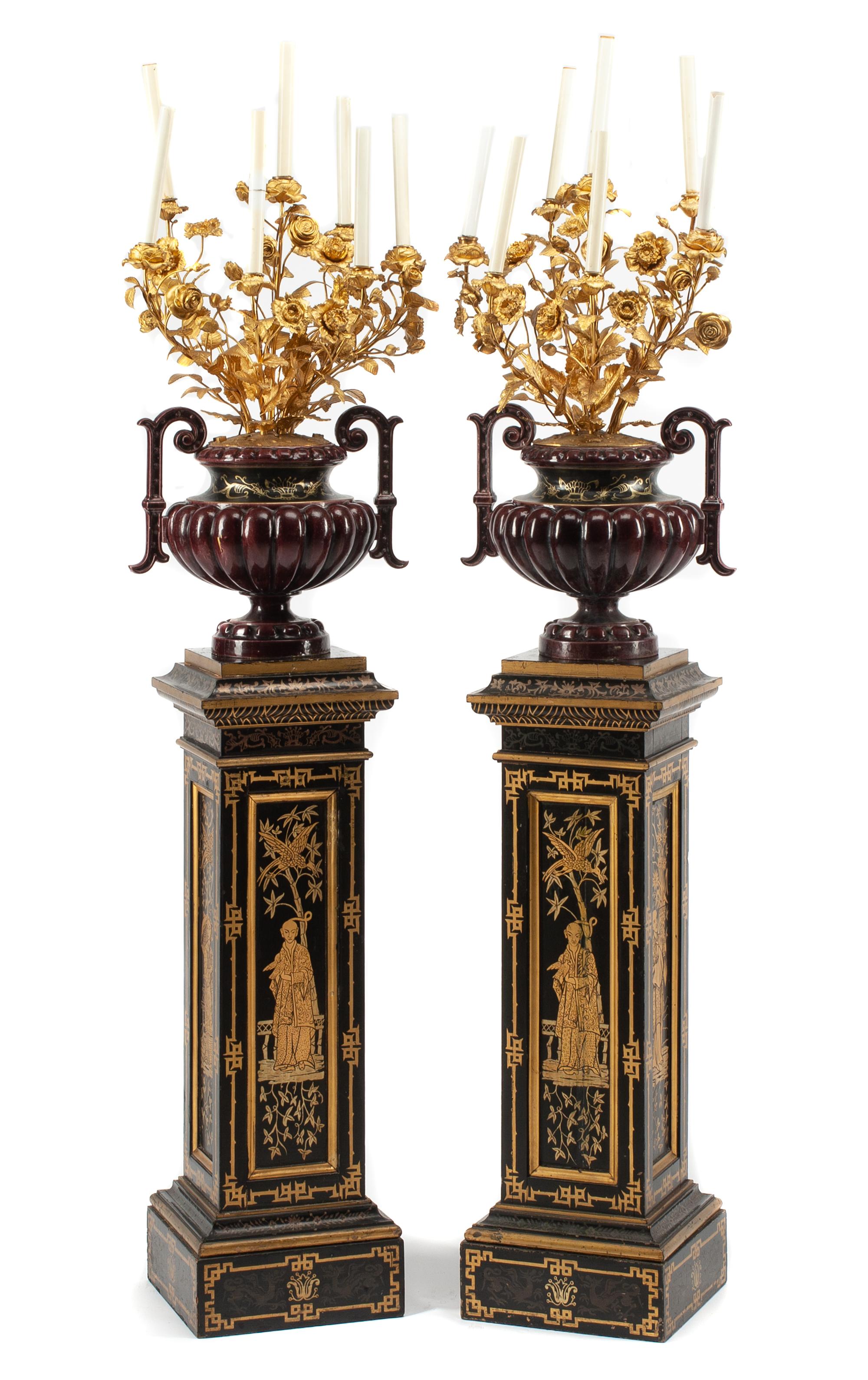 A Pair of French Enameled Cast Iron and Gilt Bronze Candelabra with Associated Painted Pedestals Height overall 69 inches.