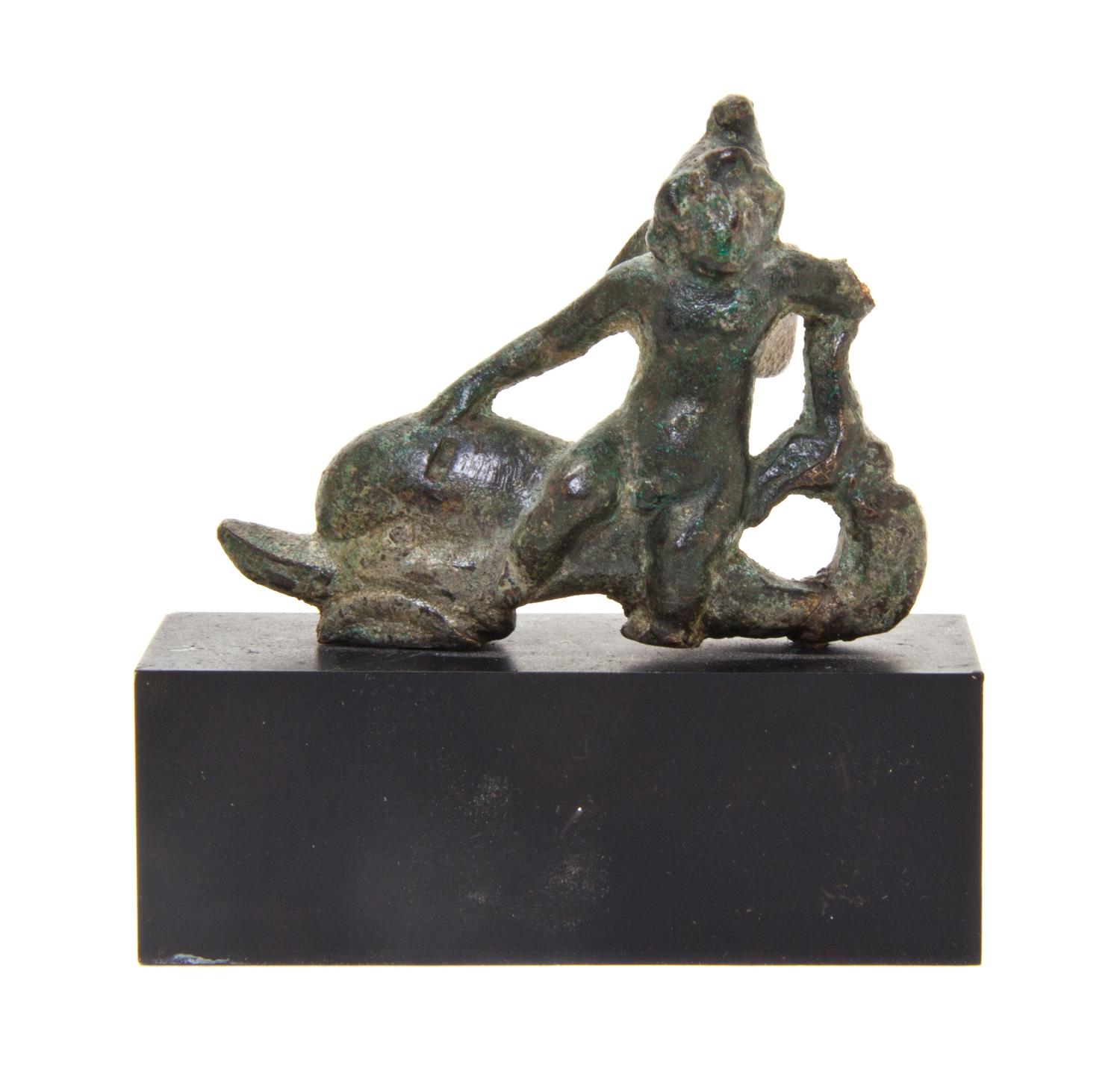 A Roman Bronze Eros Riding a Dolphin
