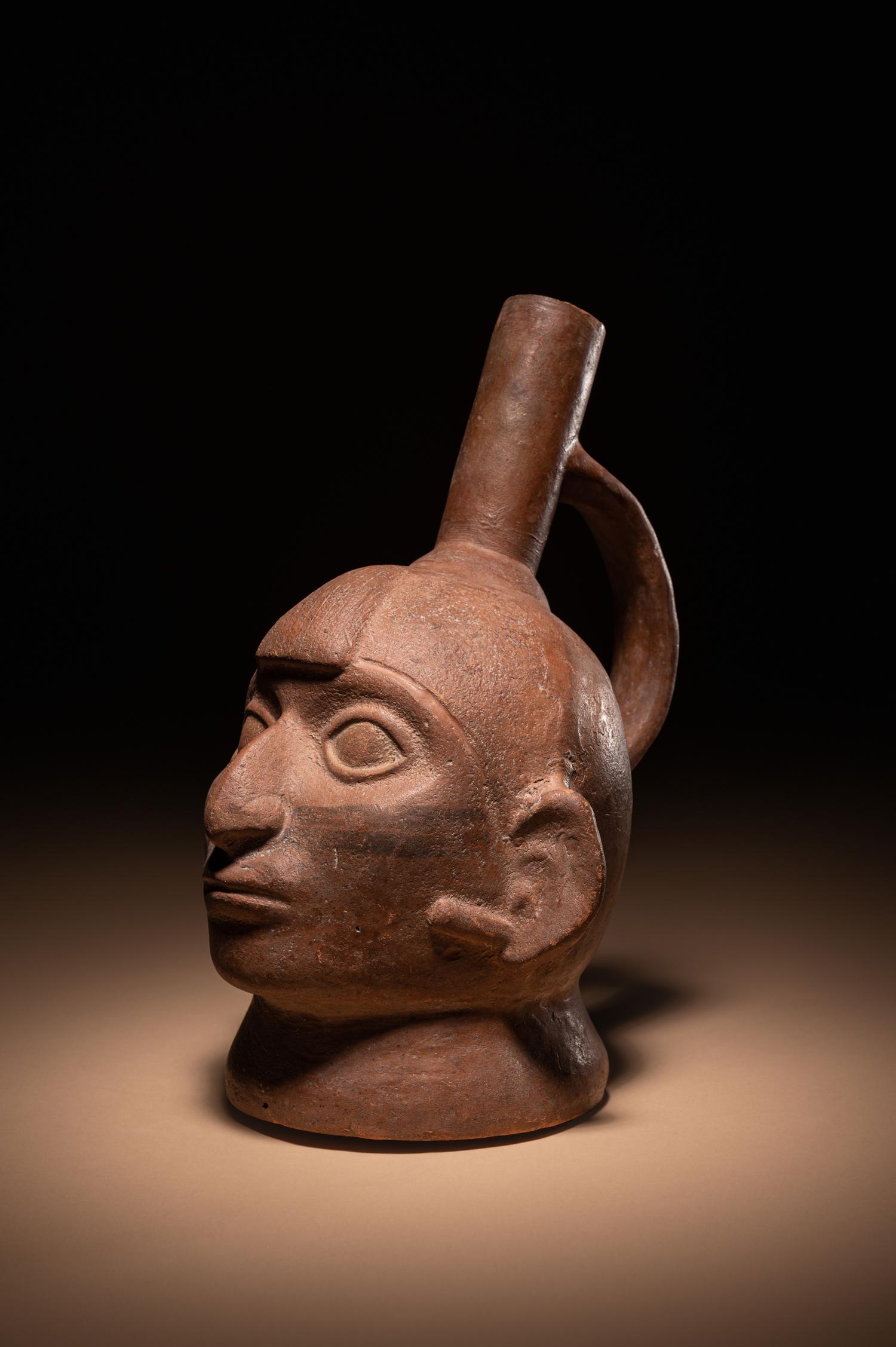 A Moche Warrior Face Stirrup Vessel