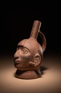 A Moche Warrior Face Stirrup Vessel