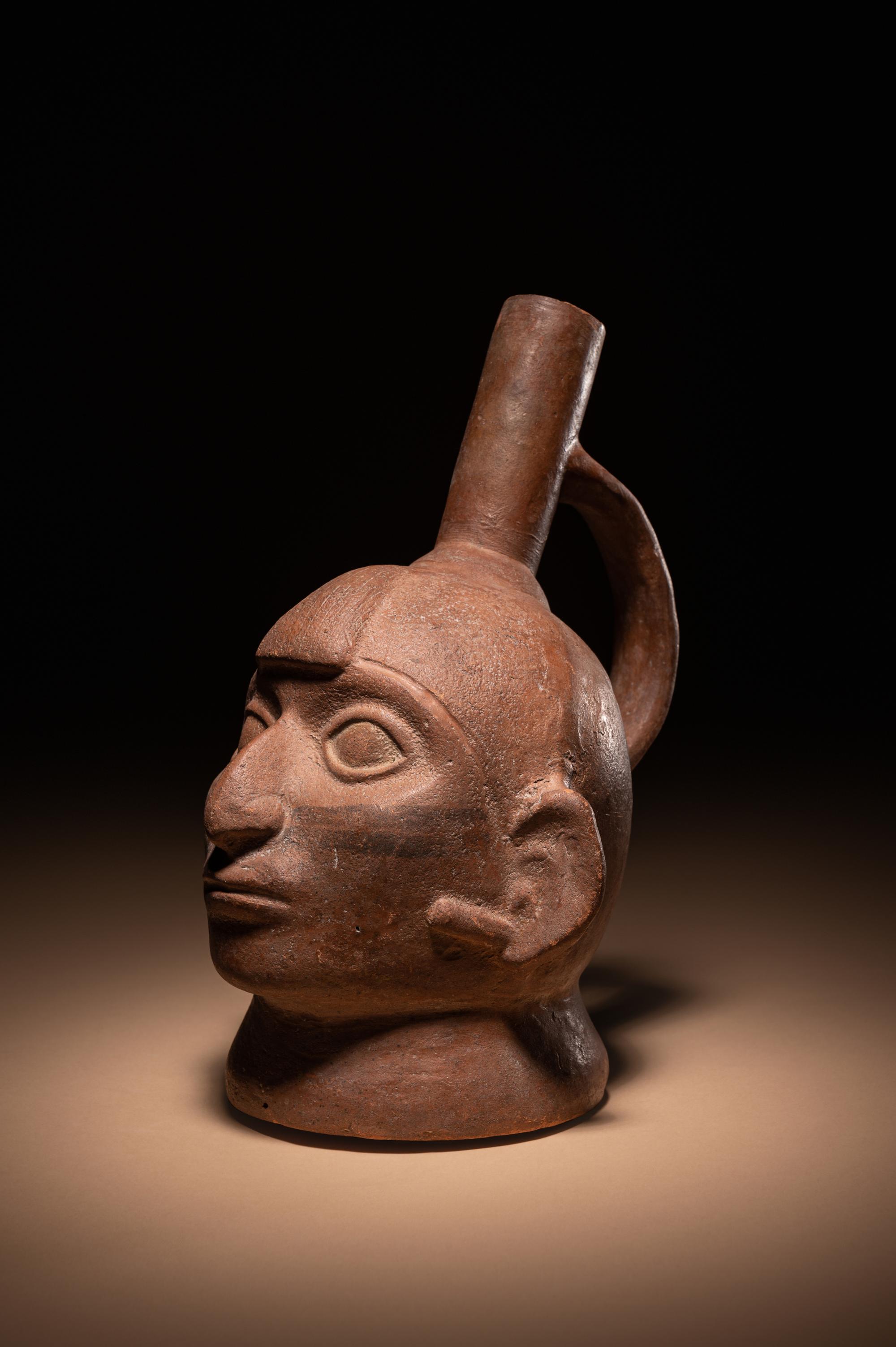 A Moche Warrior Face Stirrup Vessel