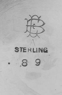 An American Silver Pitcher, Maker's Mark EB, having a paneled body with a foliate decorated band and an engraved monogram.
