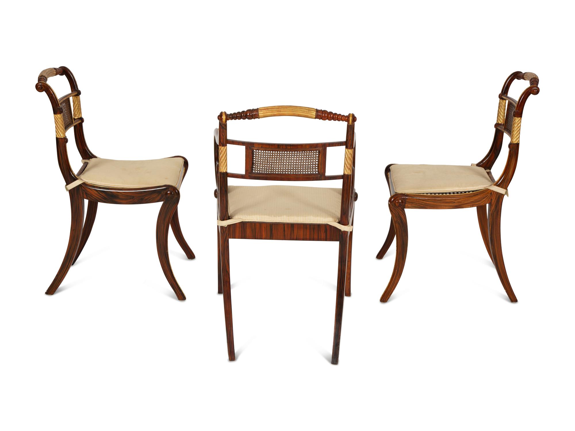 A Set of Fourteen Regency and Regency Style Rosewood and Parcel Gilt Dining Chairs