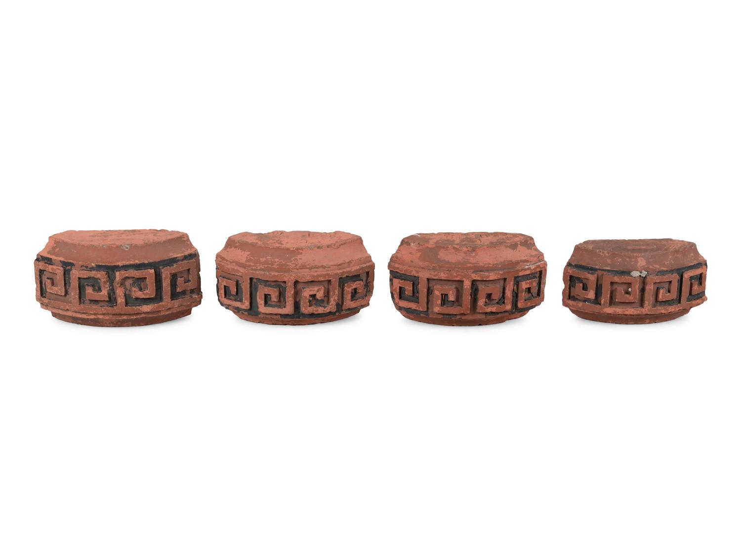 A Set of Four Continental Terra Cotta Ornaments