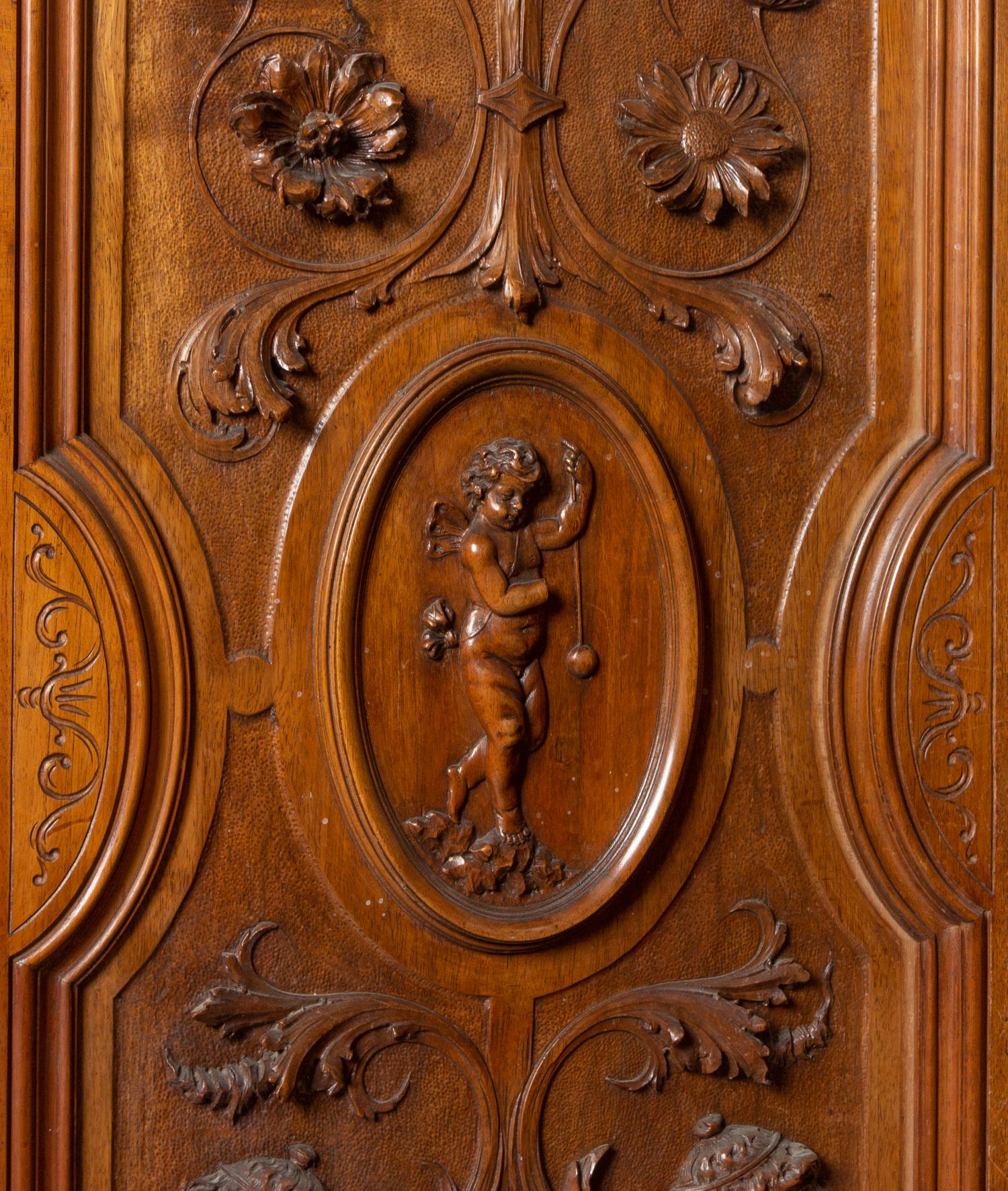 An Italian Renaissance Revival Carved Walnut Armoire