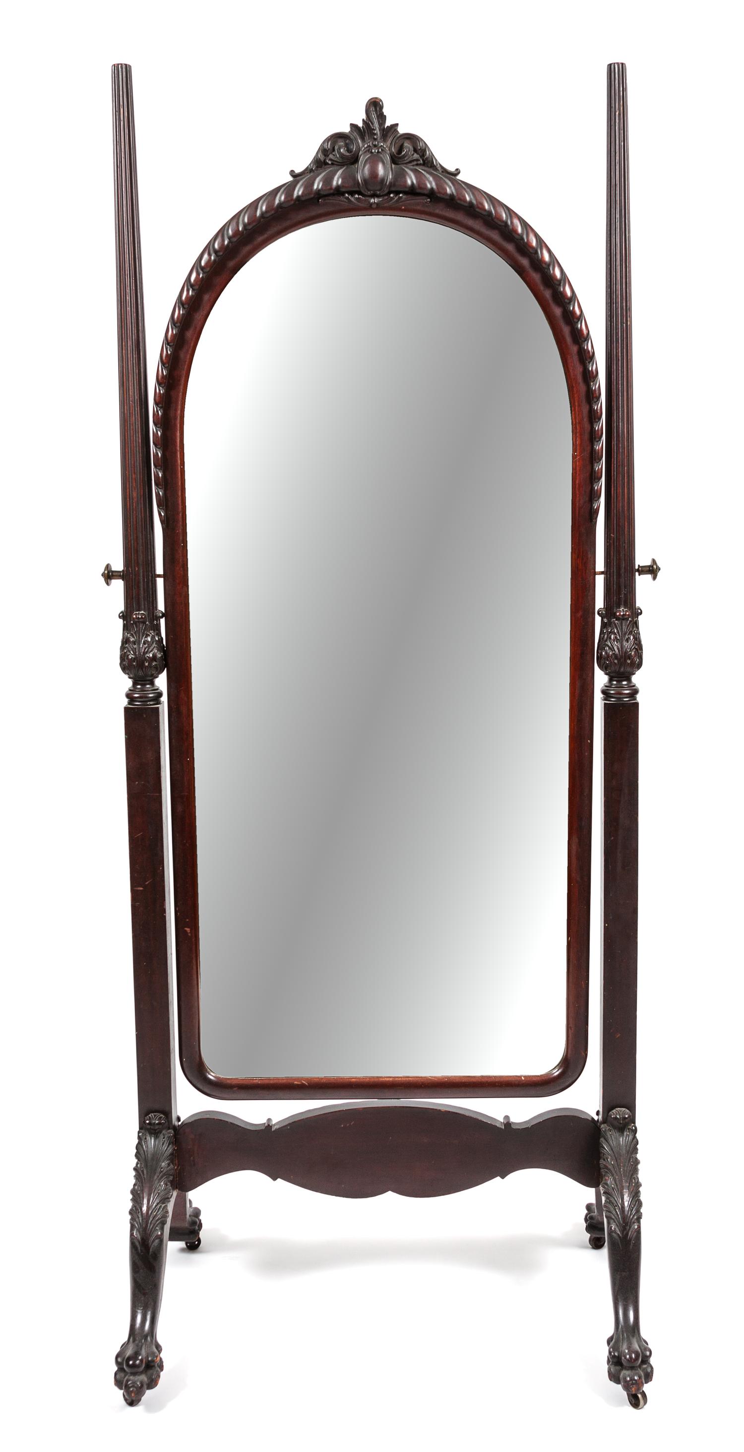 A Victorian Carved Cheval Mirror Height 79 x width 33 x depth 23 1/2 inches.