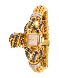 GÜBELIN, YELLOW GOLD, SAPPHIRE AND DIAMOND SURPRISE WATCH