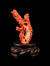 A Red Coral Carving of Squirrels and Grapes