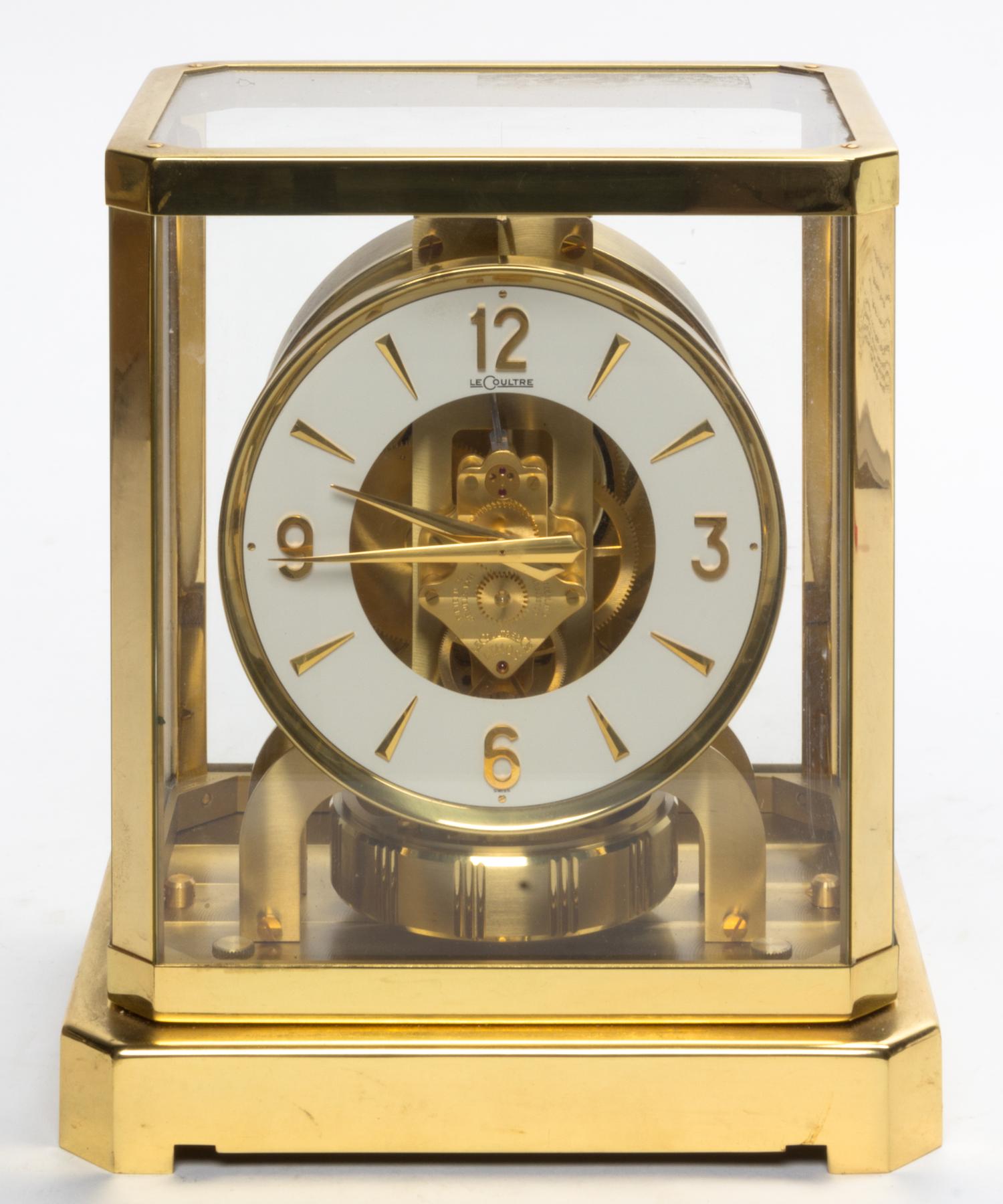 A Swiss Brass and Glass Atmos Clock, LeCoultre Height 9 1/4 x width 8 1/4 x depth 6 1/2 inches.
