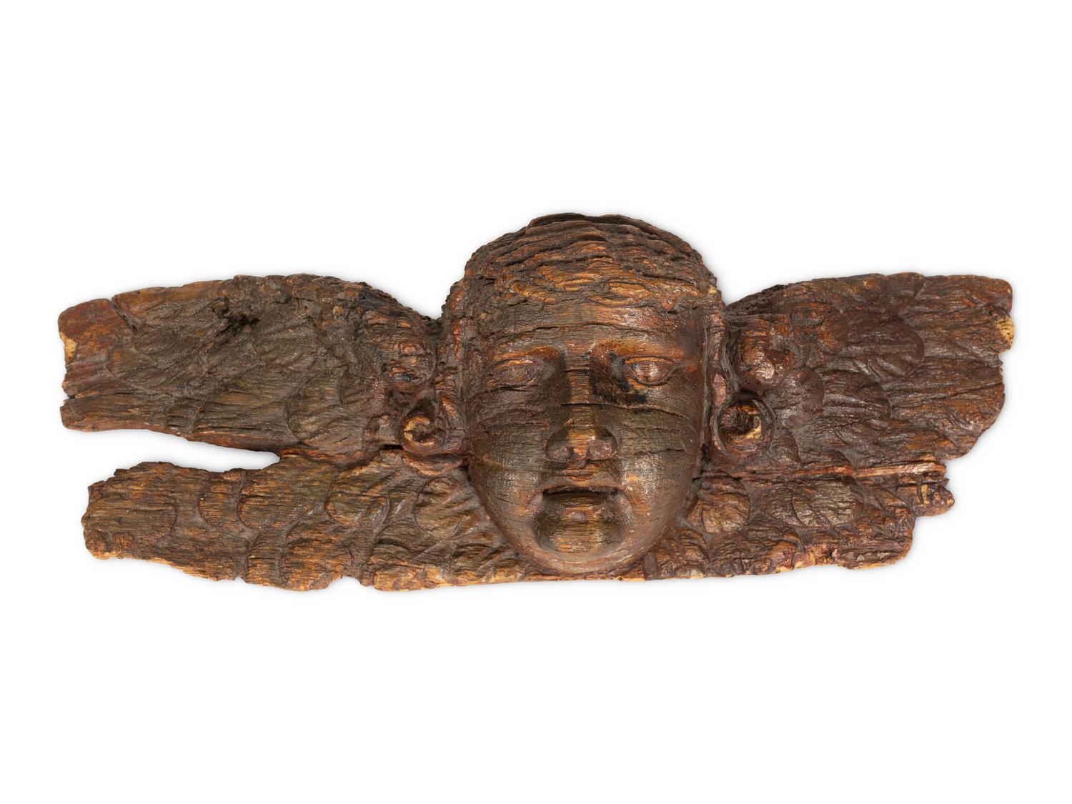 A Continental Baroque Carved Walnut Putto Mask