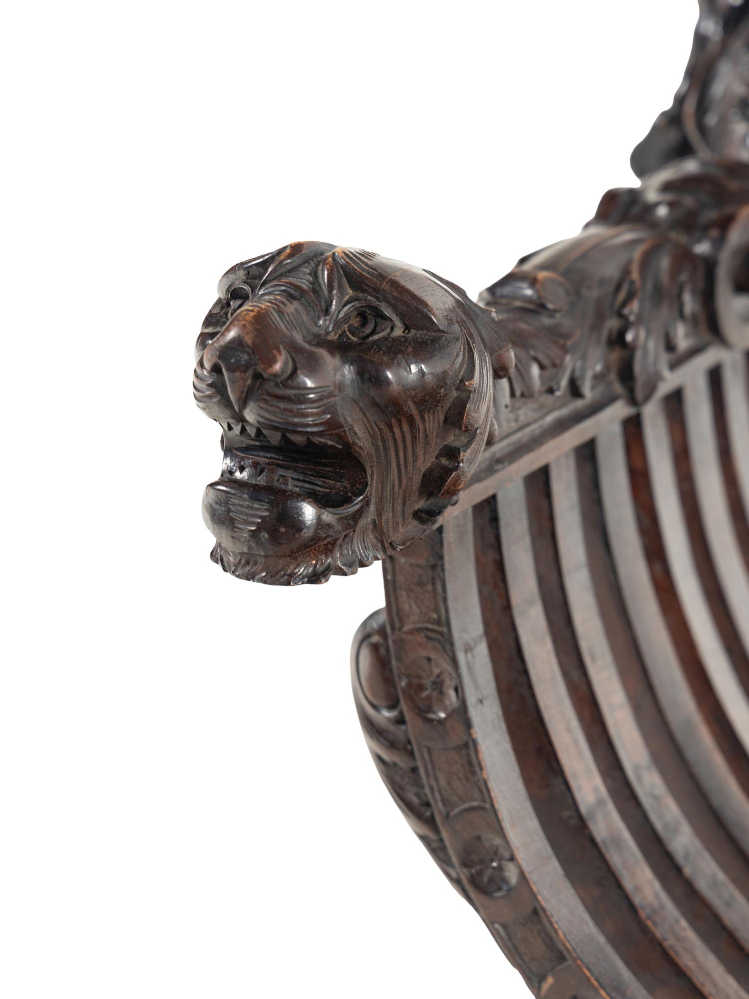 An Italian Renaissance Revival Carved Walnut Savonarola Armchair