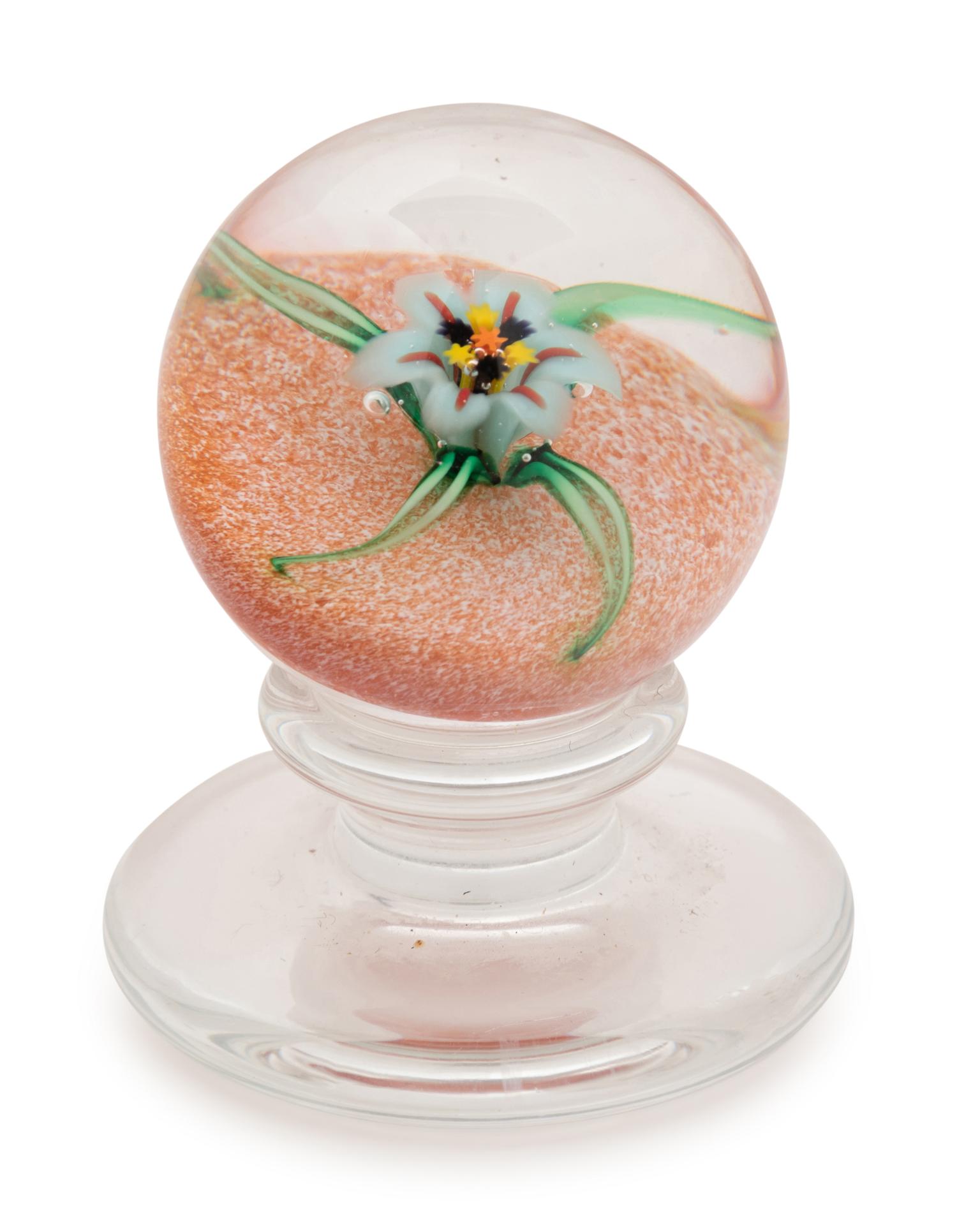 A Charles Kaziun Jr. White Spider Lily on Orange Ground Miniature Tilted Pedestal Glass Paperweight