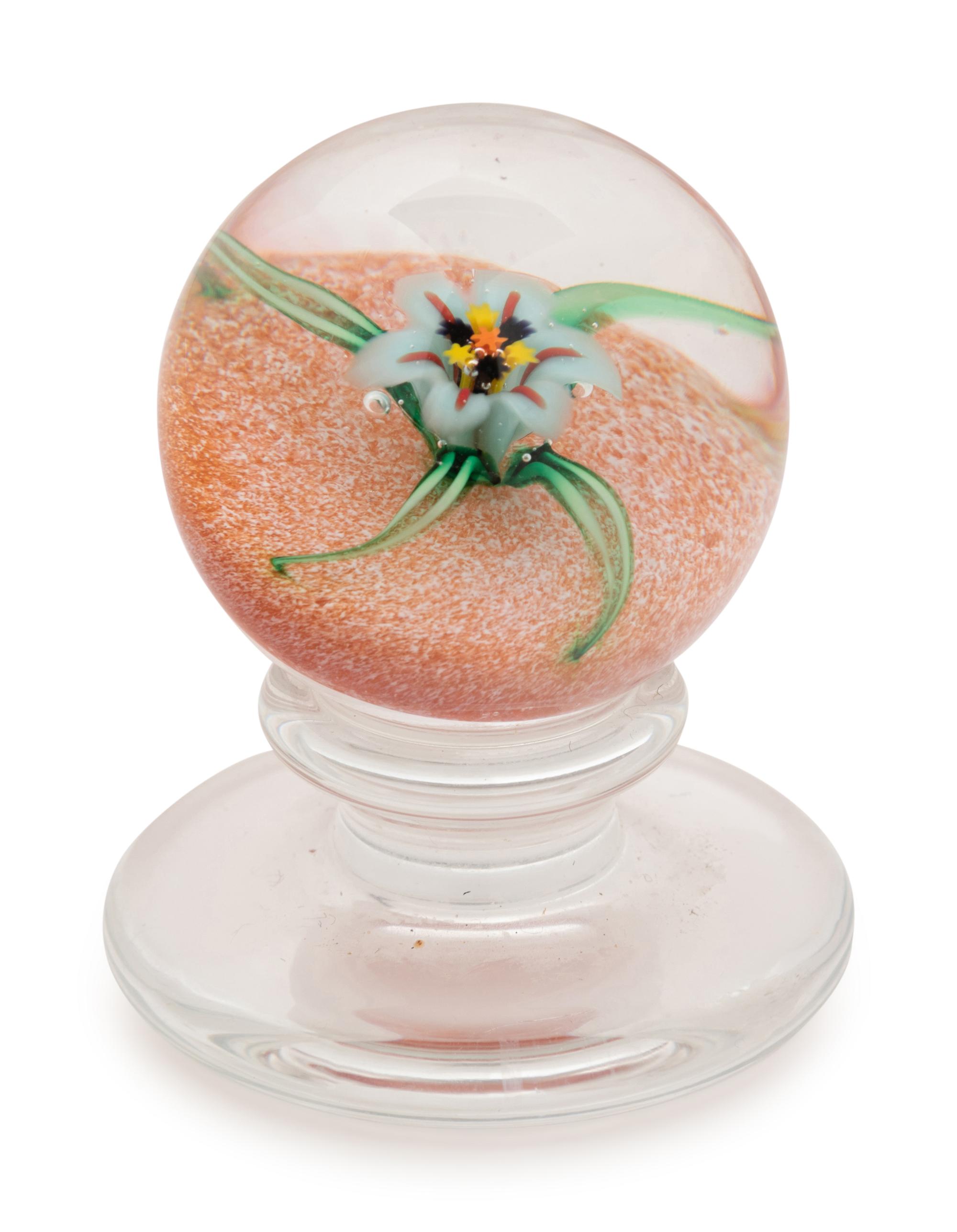 A Charles Kaziun Jr. White Spider Lily on Orange Ground Miniature Tilted Pedestal Glass Paperweight