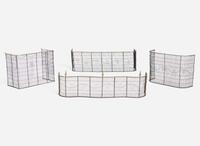 A group of four Federal brass and wirework fireplace screens and fenders, circa 1800