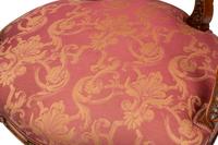A Pair of Louis XV Style Carved Walnut Fauteuils