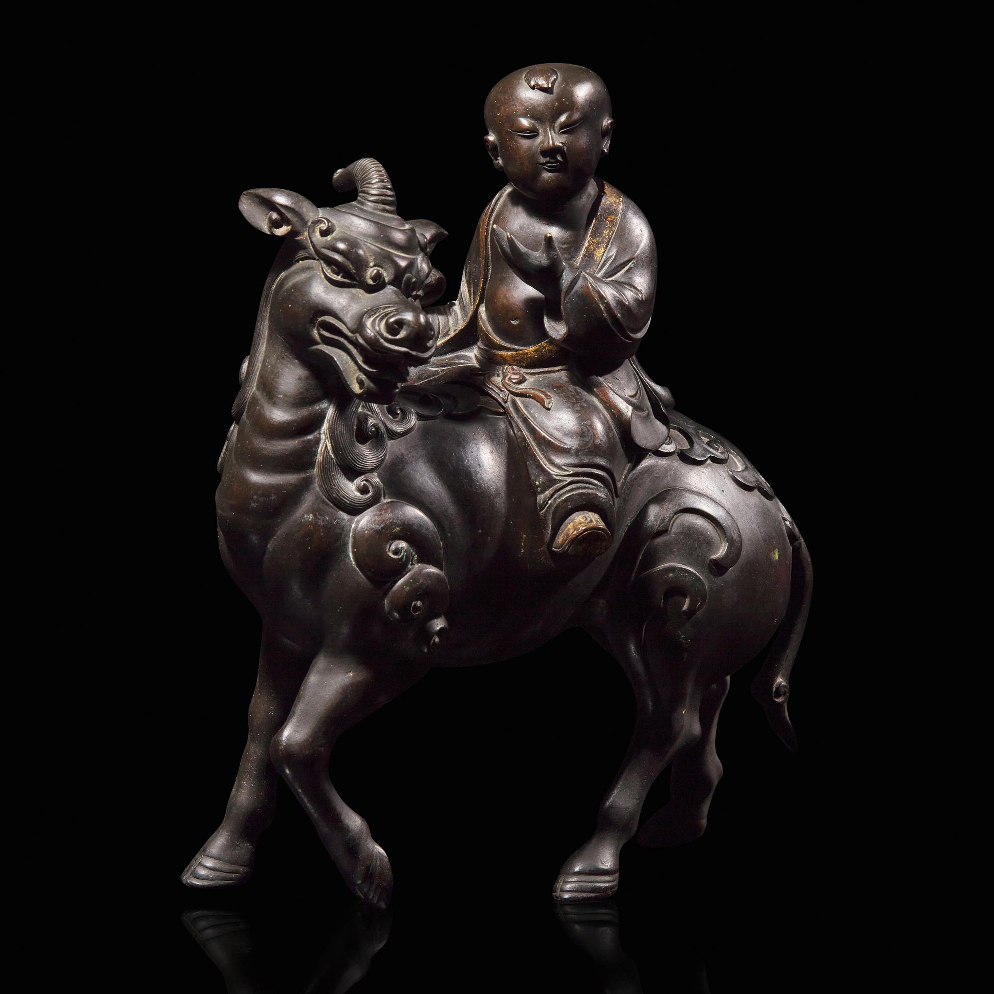 A Chinese Patinated and Parcel-gilt Bronze 'Qilin and Boy' Censer, 17th/18th Century 清早期 銅局部鎏金麒麟童子香薰