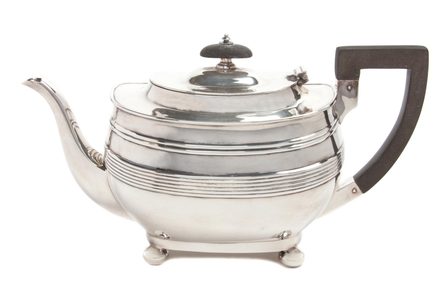 An English Silver Teapot, George Hape, Sheffield, 1906, of low form with banded decoration, with a wood handle and finial.