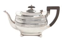 An English Silver Teapot, George Hape, Sheffield, 1906, of low form with banded decoration, with a wood handle and finial.
