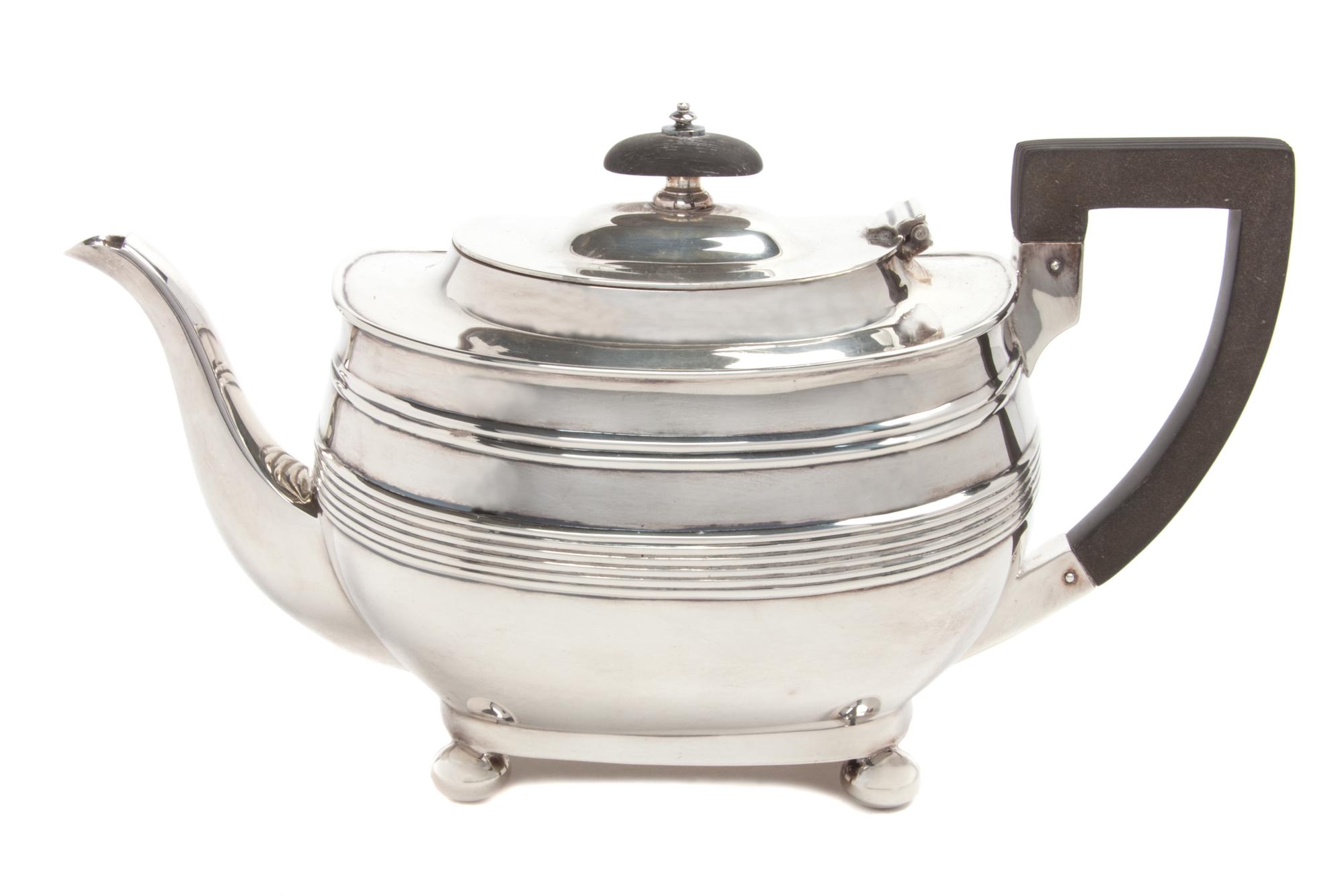 An English Silver Teapot, George Hape, Sheffield, 1906, of low form with banded decoration, with a wood handle and finial.
