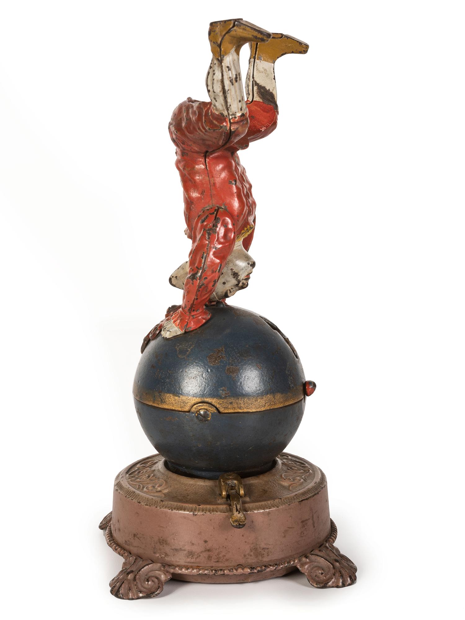 A Spinning Clown on Globe Cast Iron Mechanical Bank