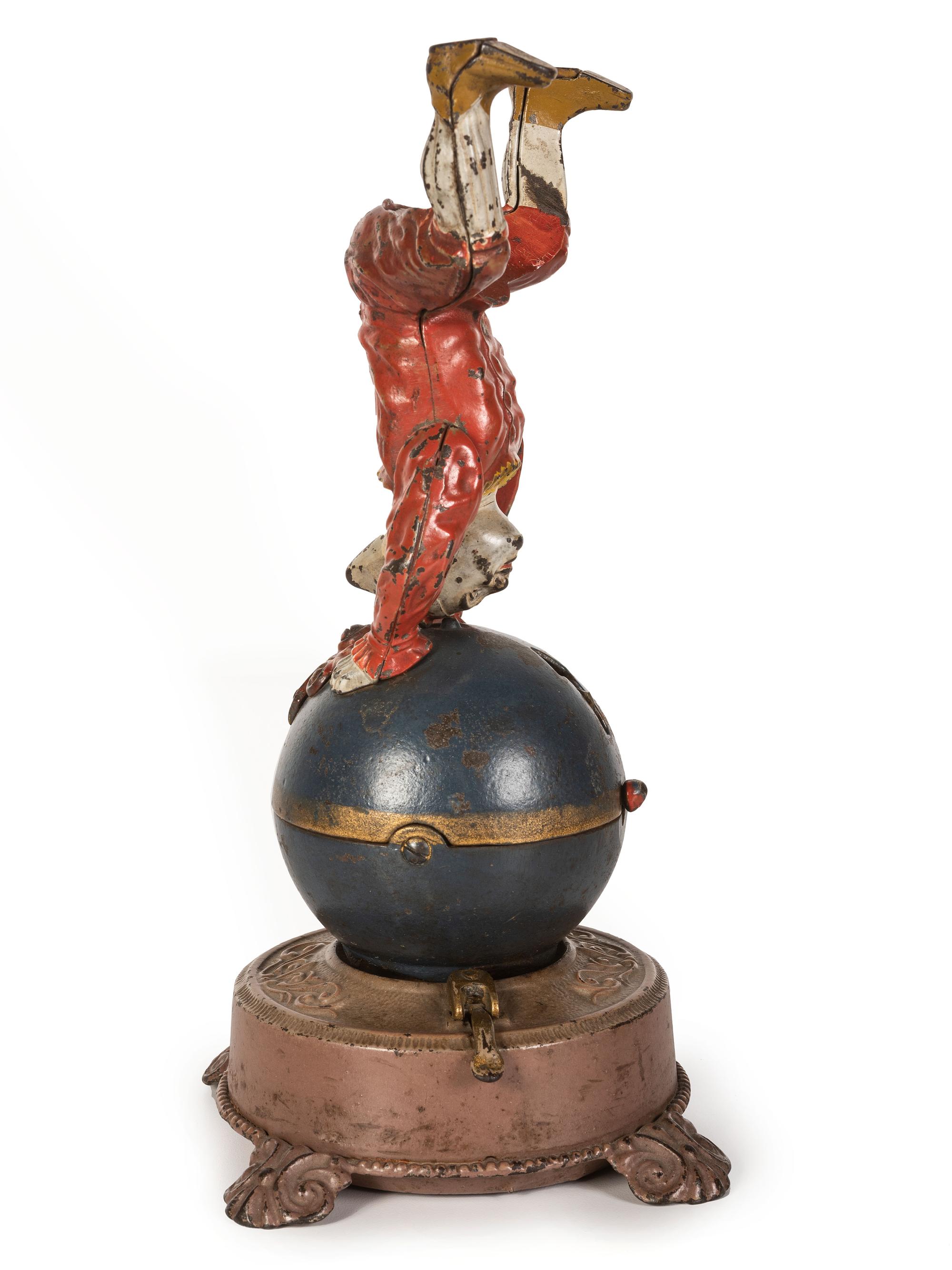A Spinning Clown on Globe Cast Iron Mechanical Bank