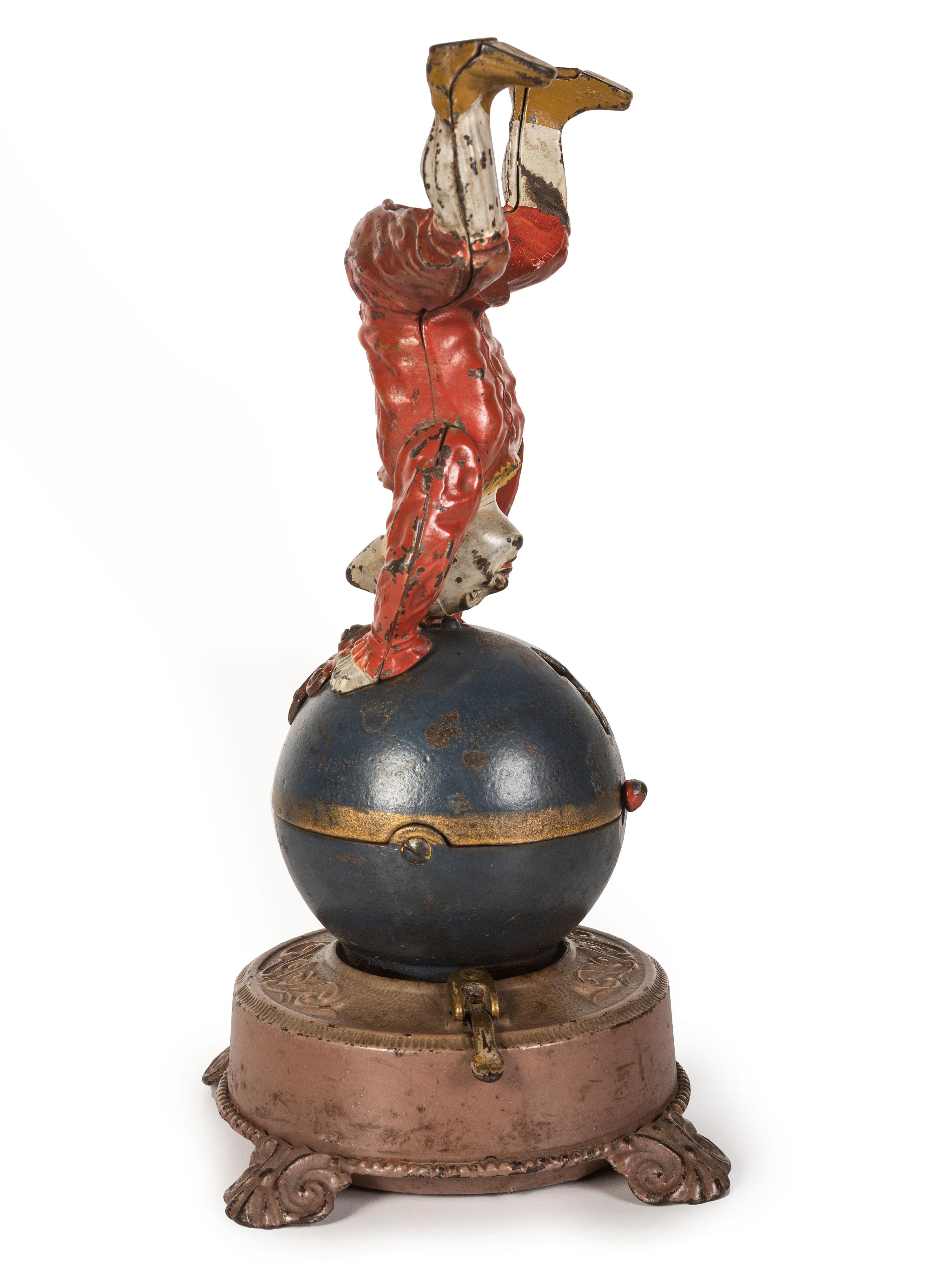 A Spinning Clown on Globe Cast Iron Mechanical Bank