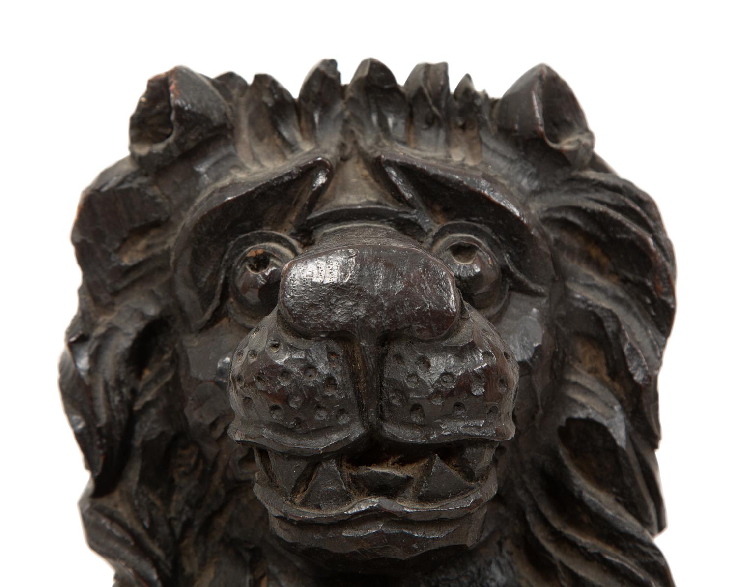 An English Carved and Stained Oak Figure of a Lion