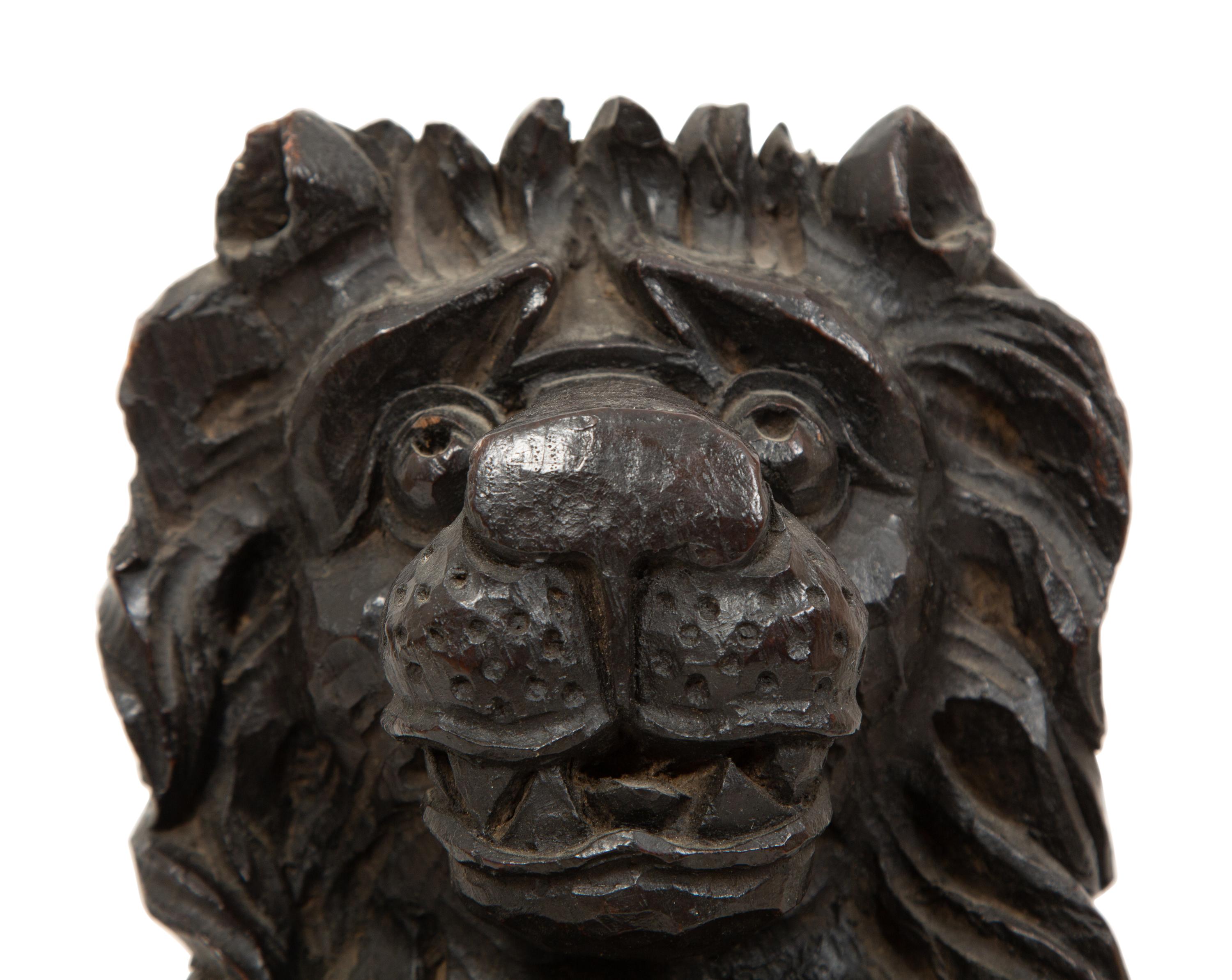 An English Carved and Stained Oak Figure of a Lion