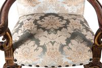 A Pair of Italian Baroque Style Parcel Gilt Walnut Armchairs