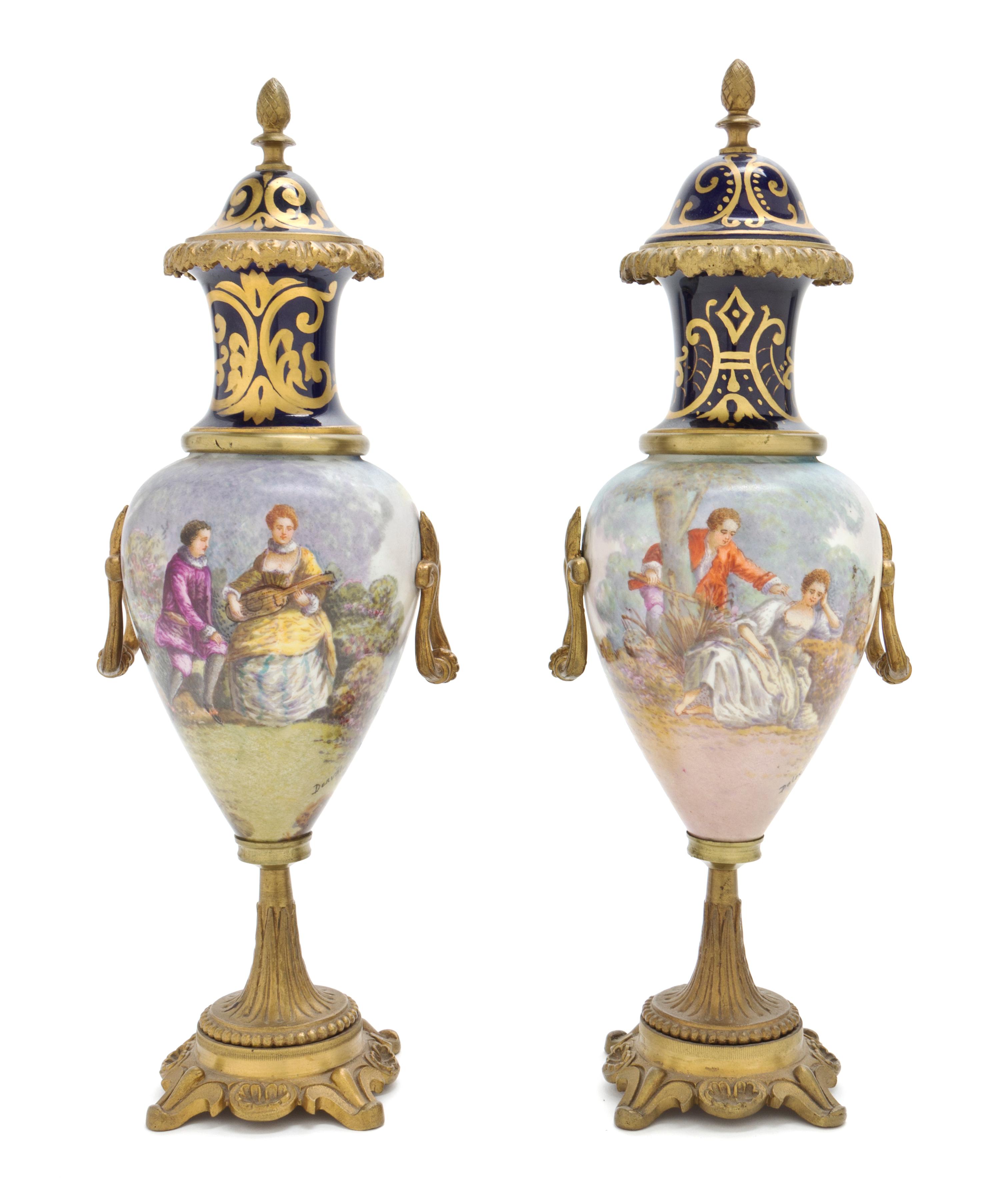 A Pair of Sevres Style Gilt Metal Mounted Porcelain Urns, Height 12 7/8 inches