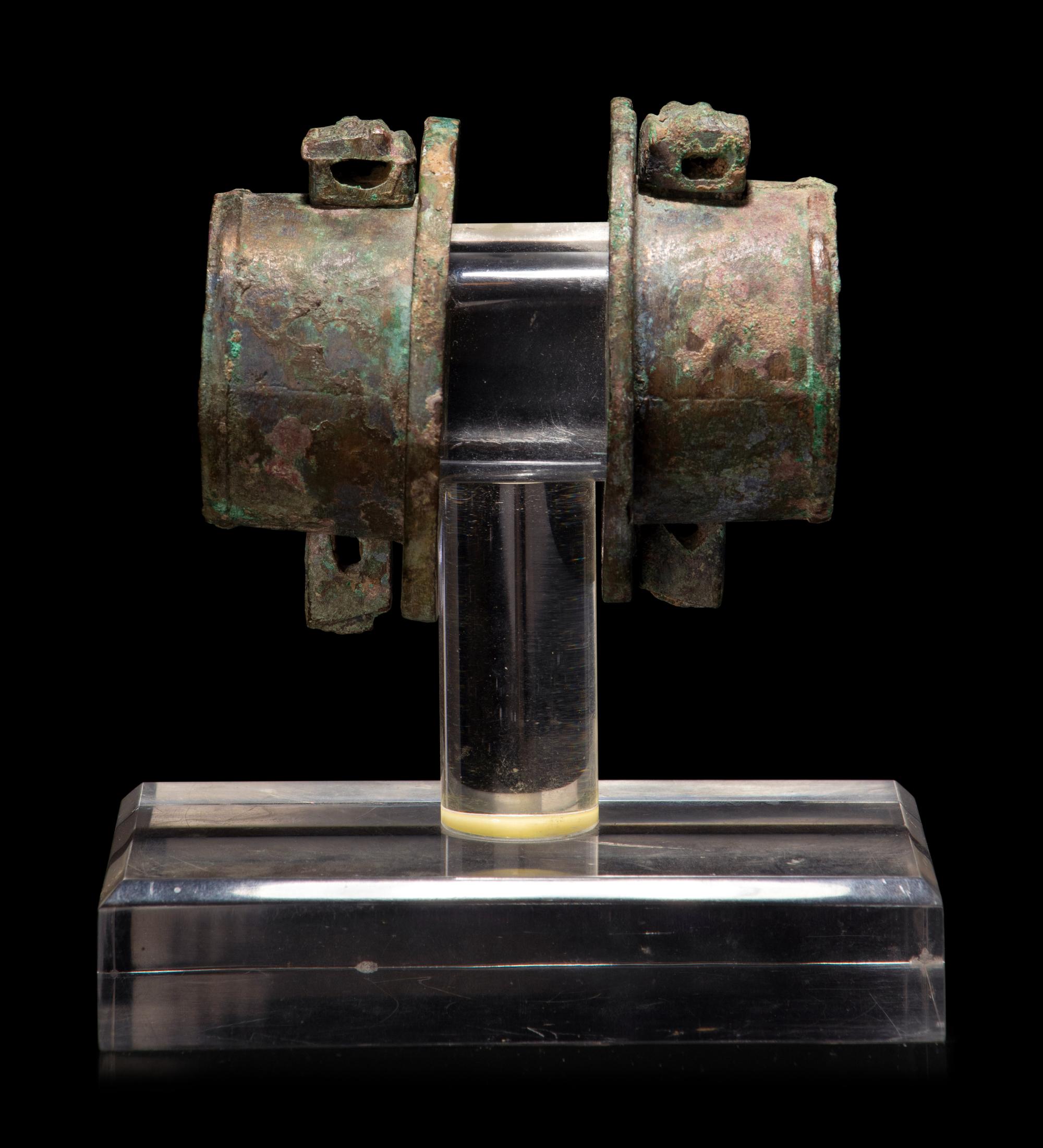 A Pair of Chinese Archaic Bronze Axle Covers and Linchpins