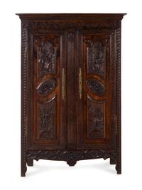 A Brittany Style Carved Oak Armoire
