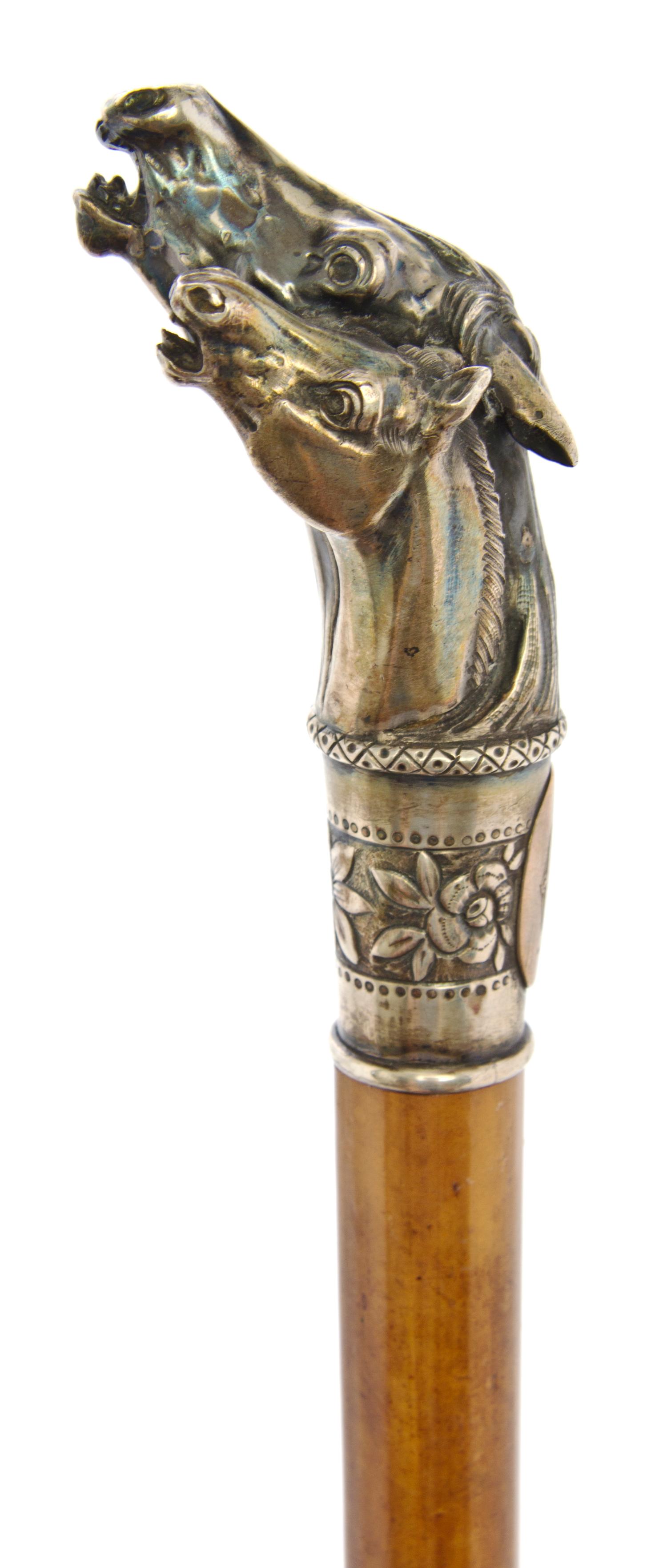 An American Sterling Silver Handled Cane, Length of handle 4 x length overall 30 1/2 inches.