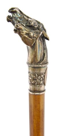 An American Sterling Silver Handled Cane, Length of handle 4 x length overall 30 1/2 inches.